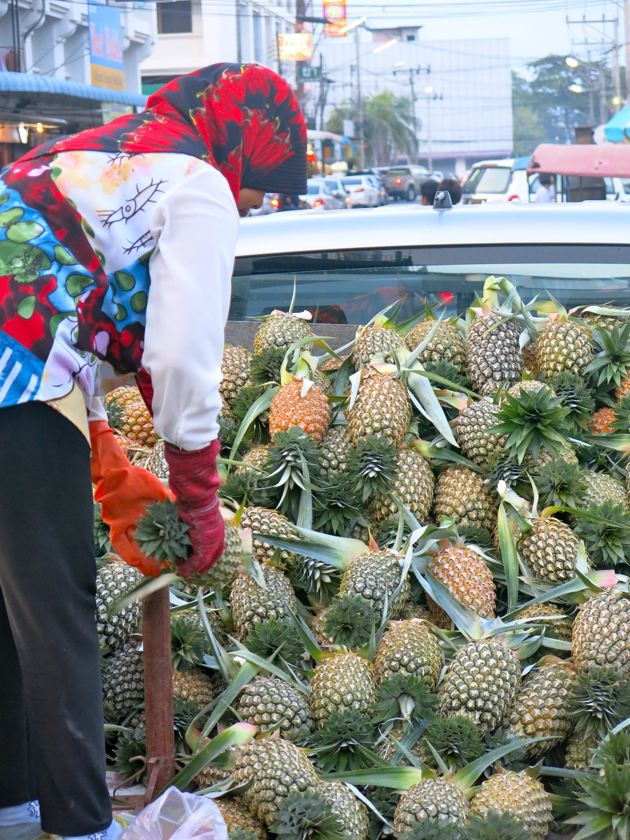 Muslim woman disembarking pineapples at Krabi Town market