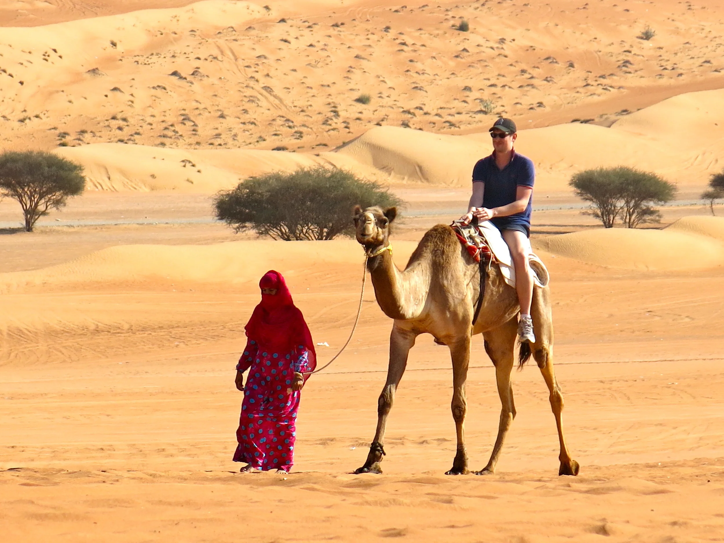 Camel ride with a Beduin woman in the Wahiba Sands desert