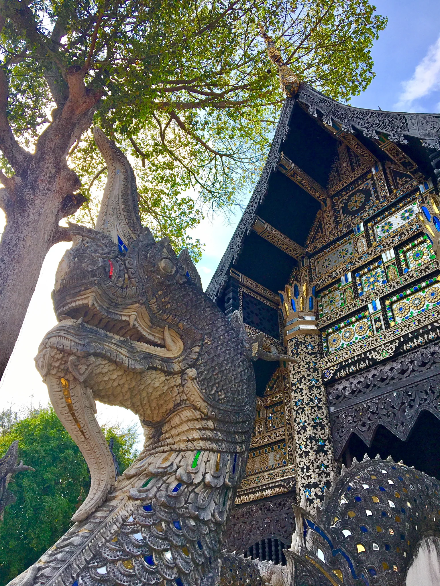 Naga guarding a wooden temple at the Wat Chedi Luang