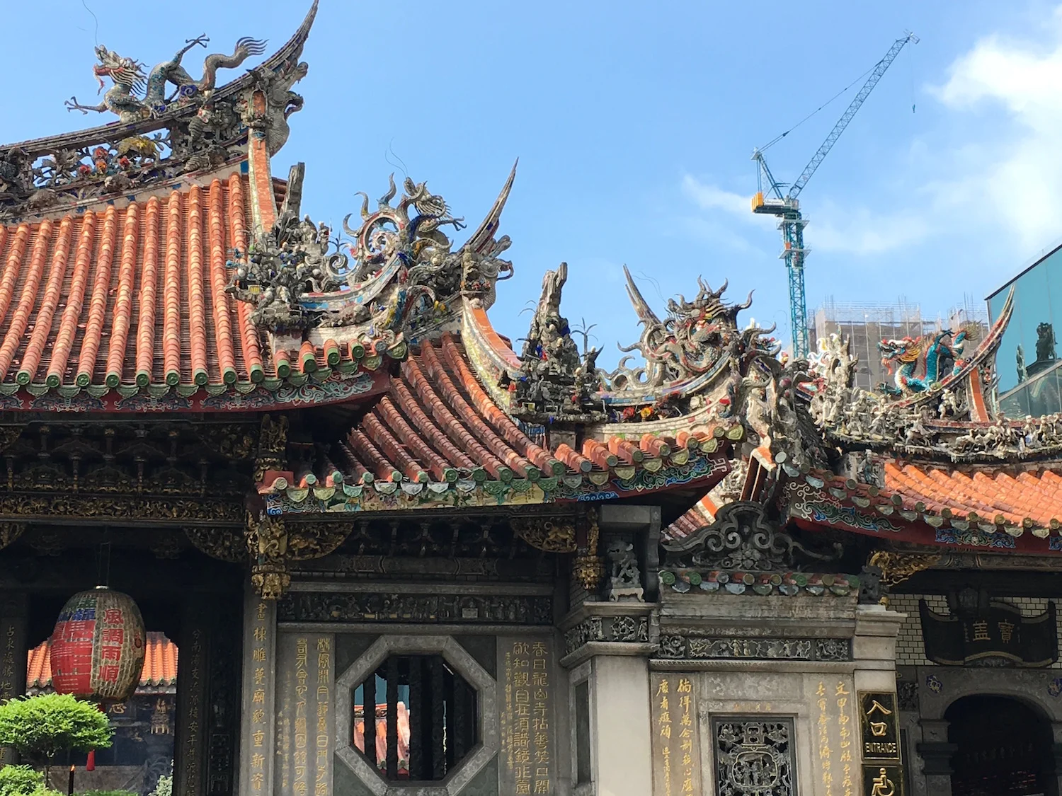 Lively Longshan Temple, established in 1738, surrounded by glass towers and new construction