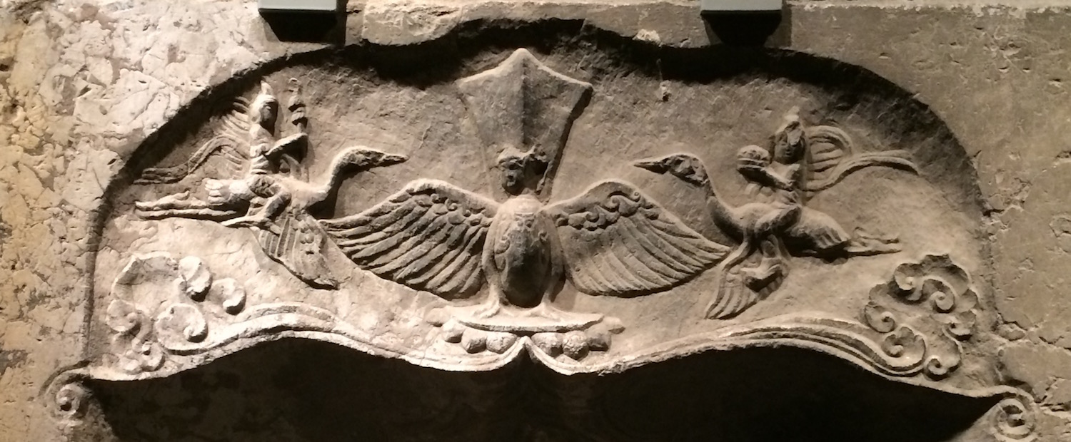 Detail showing two-headed winged figure (one head broken) with flanking celestial beings