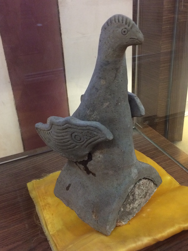 Ceramic owl roof tile in Confucius Temple museum display—a bird said to have learned from the master