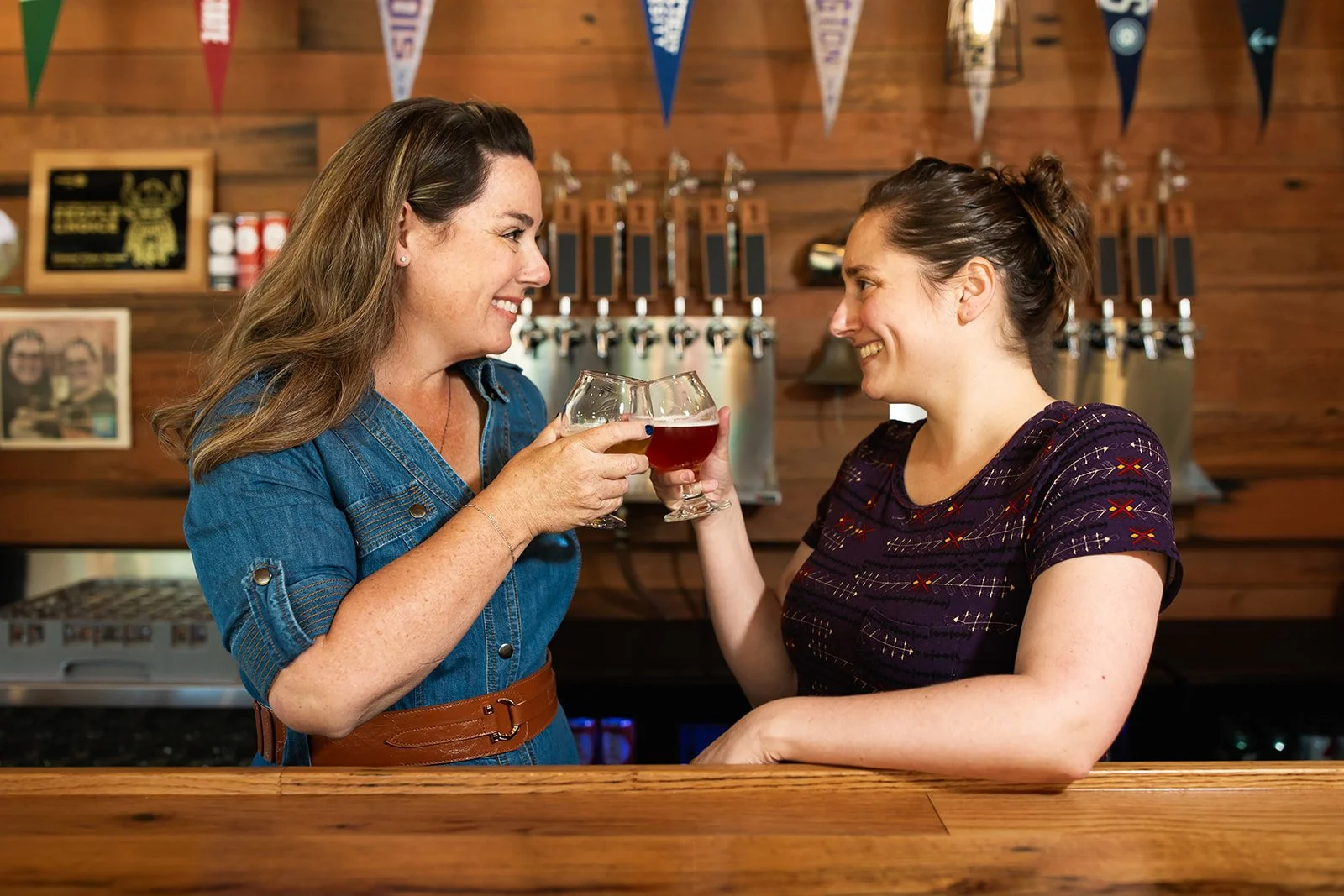 Women drinking beer at a bar
