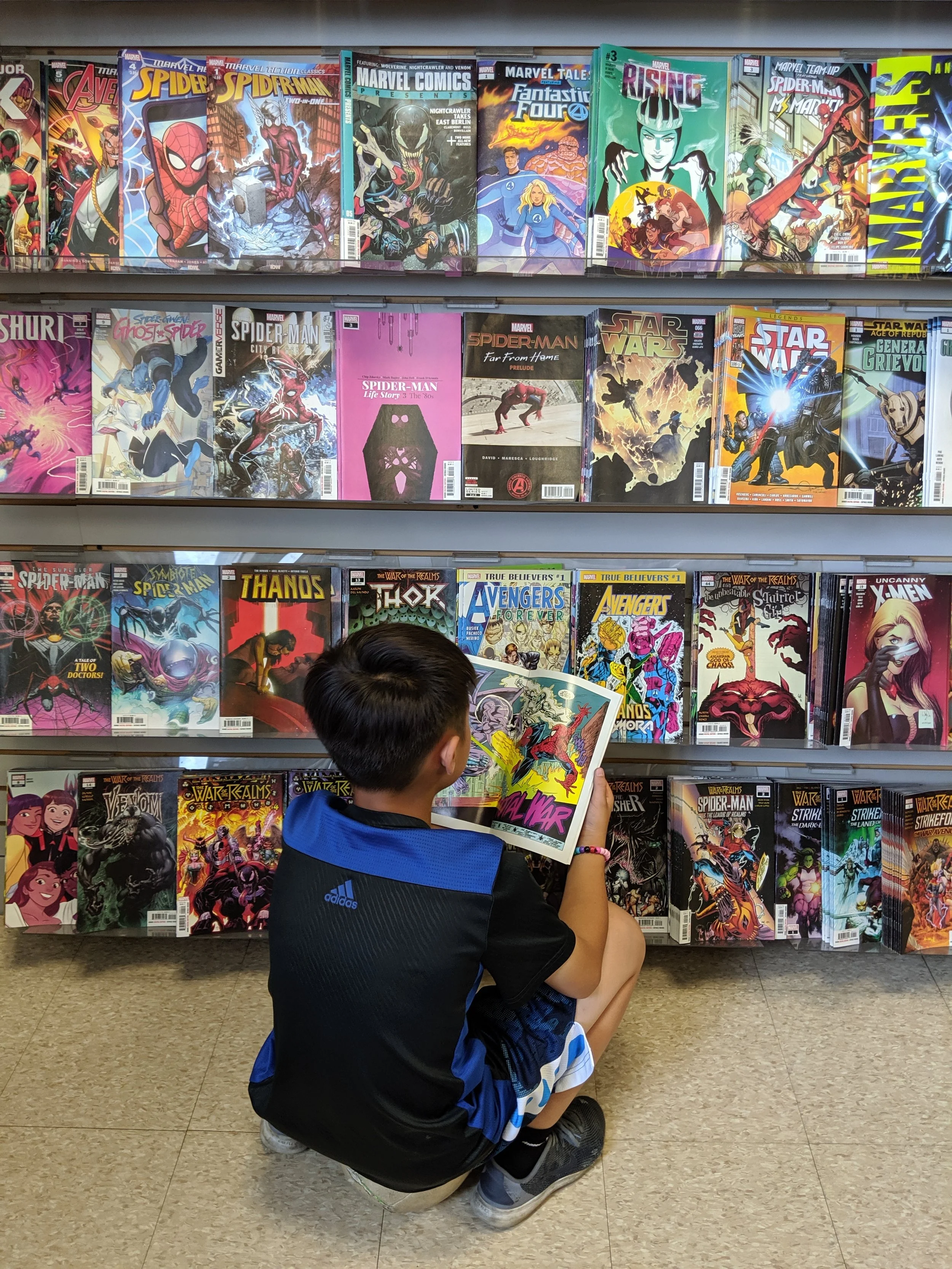 Sat on a soccer ball, reading a comic. Every boy’s natural position.