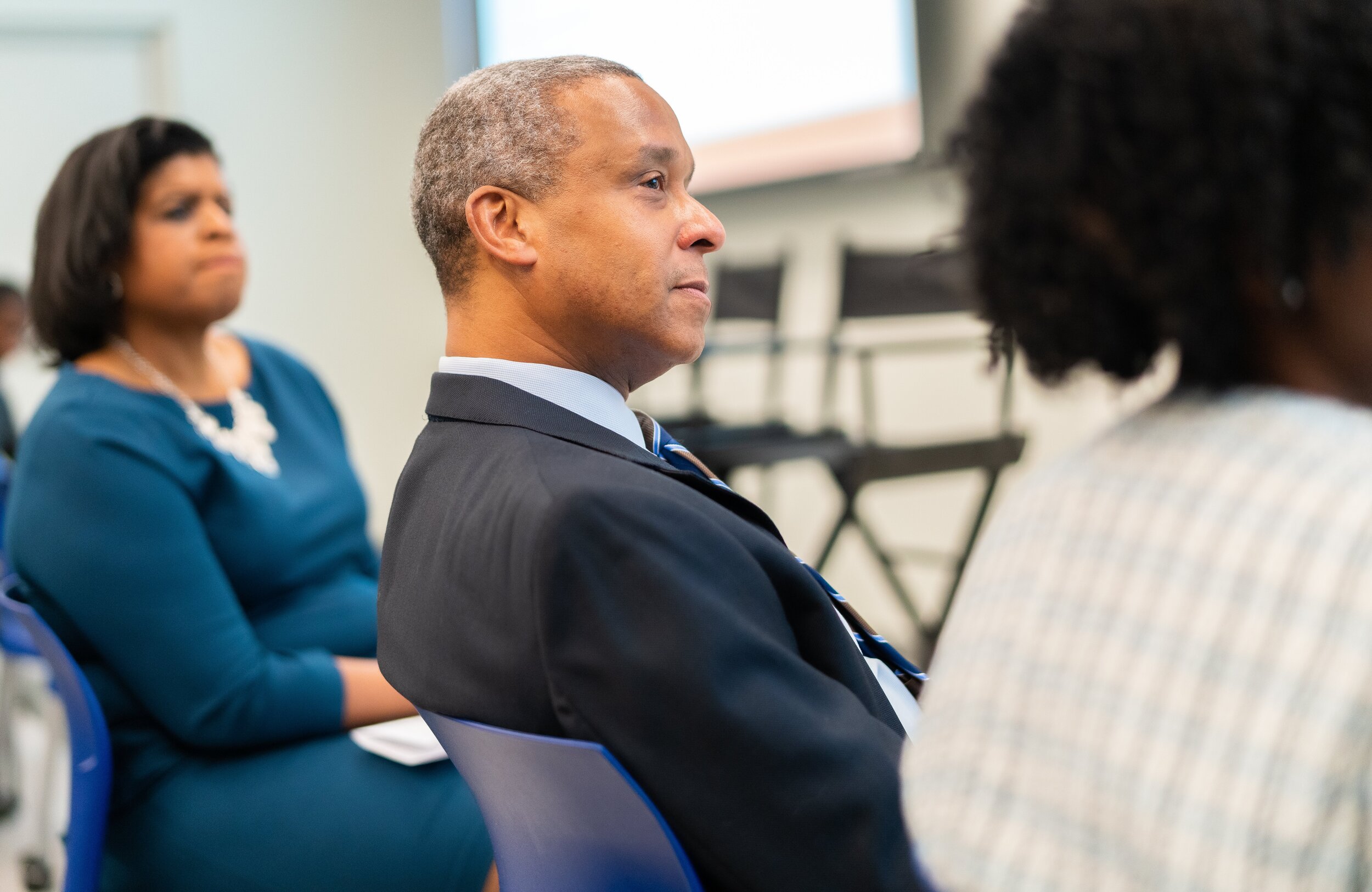   SUNY Downstate Health Sciences University President Wayne Riley listens to keynote speaker Dr. Christina Greer at Wednesday’s 27th Arthur Ashe Memorial Lecture.   
