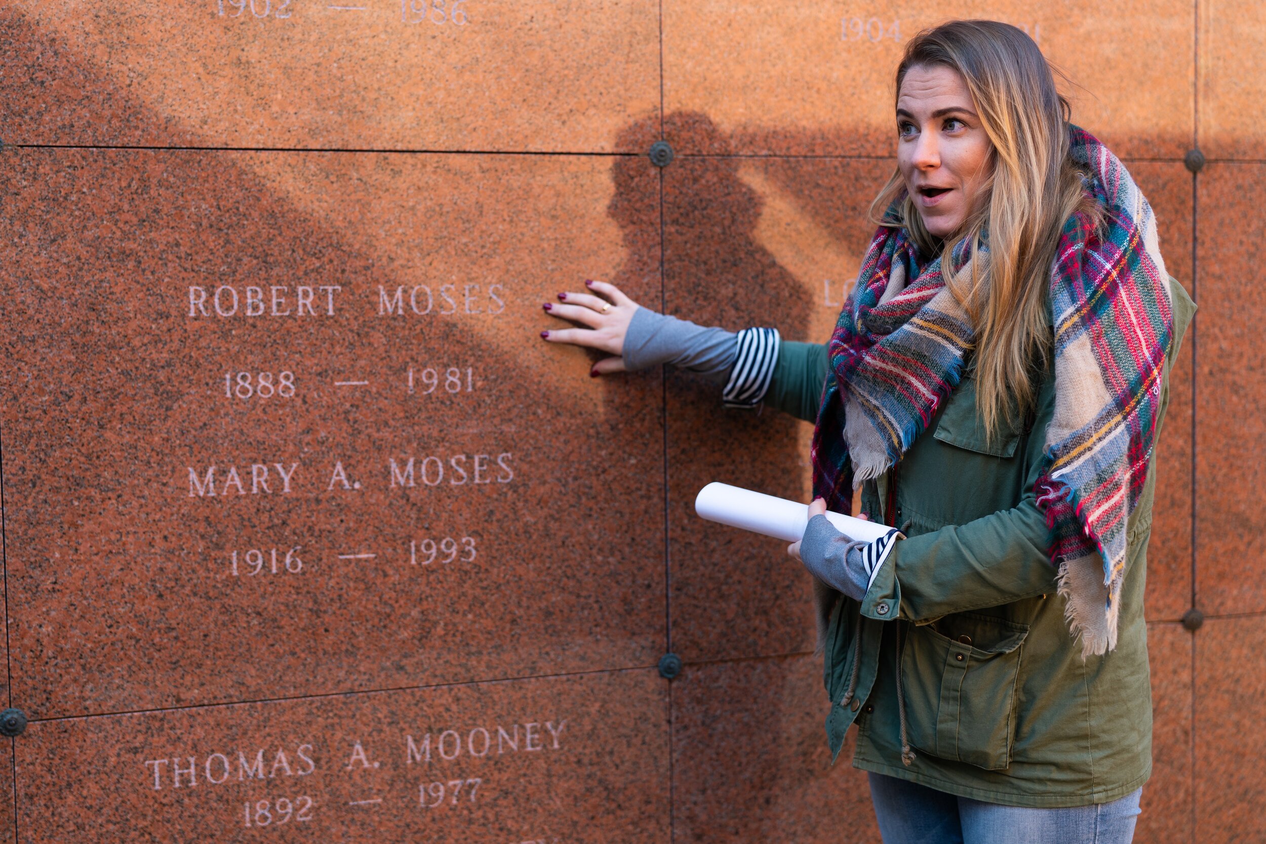   Elizabeth Cooney, Woodlawn's Coordinator of Educational Programming, stars the tour at the grave of Robert Moses.  