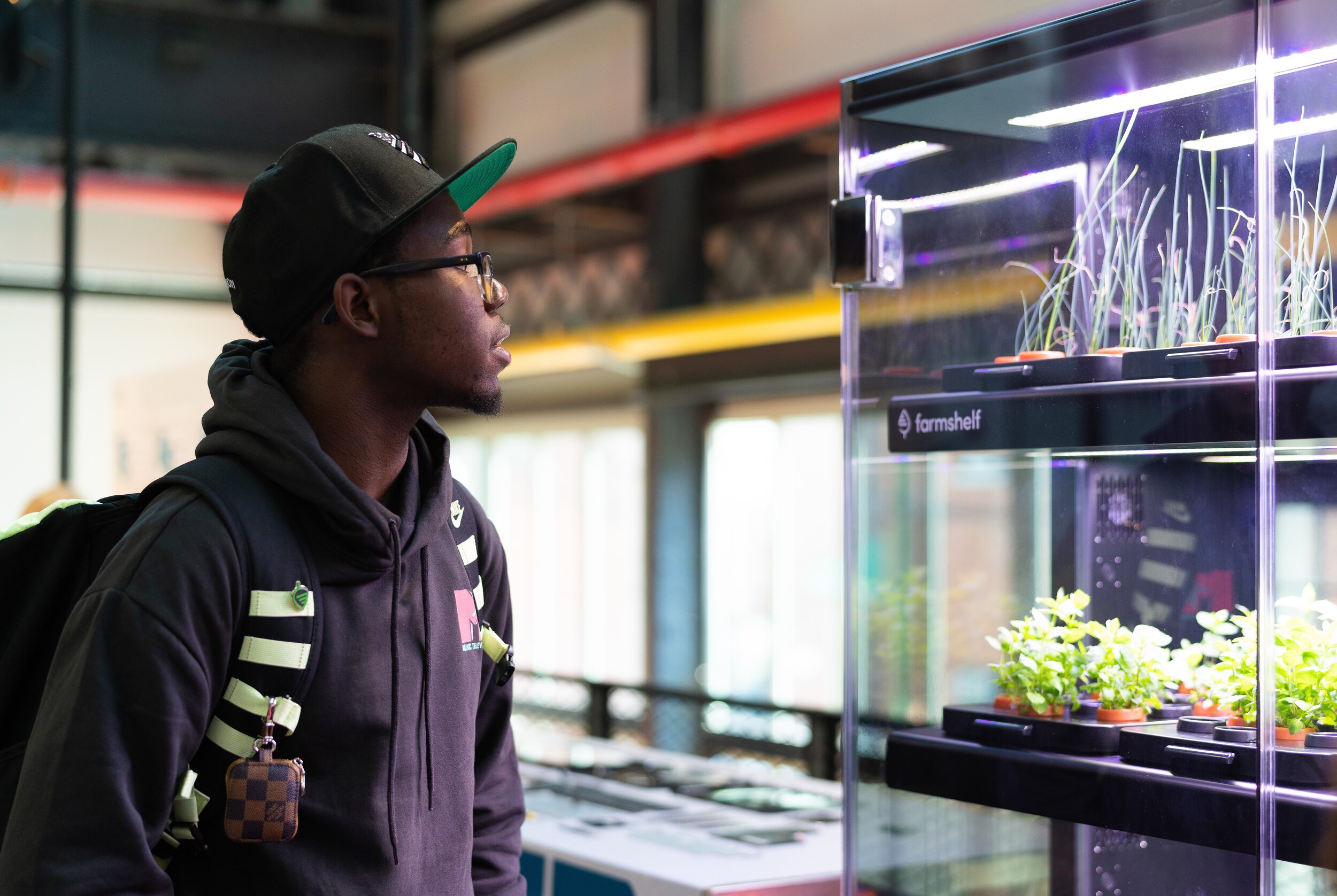   A HE3AT student examines a computer-controlled hydroponics system. An emerging technology in the field of agriculture.&nbsp;  