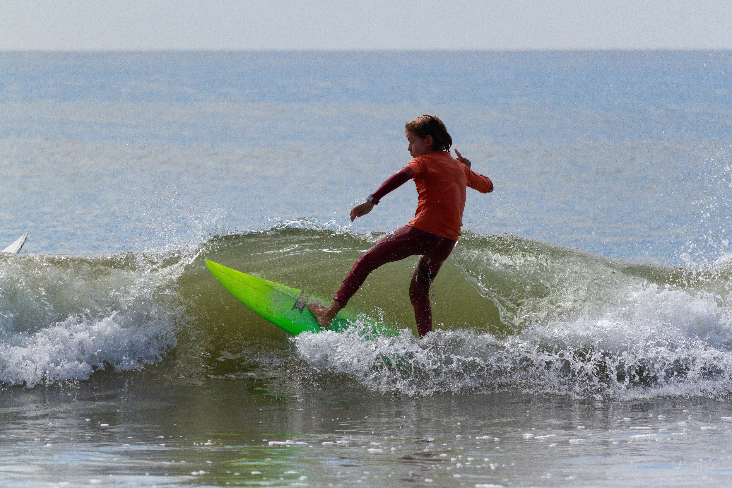   A young surfer catches a good wave at Sunday's 15th Annual Richie Allen Memorial Surf Classic.  