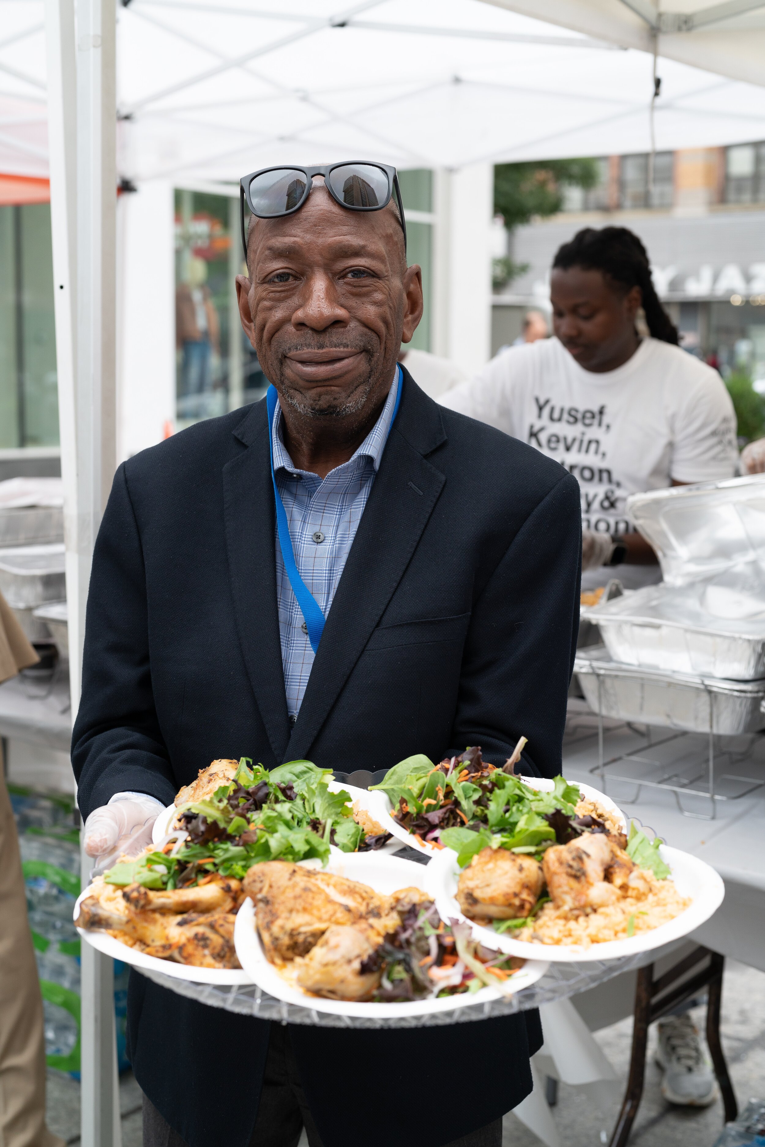   Charles Shorter, a Ryan Health employee serves lunch at Harlem's Senior Day.  