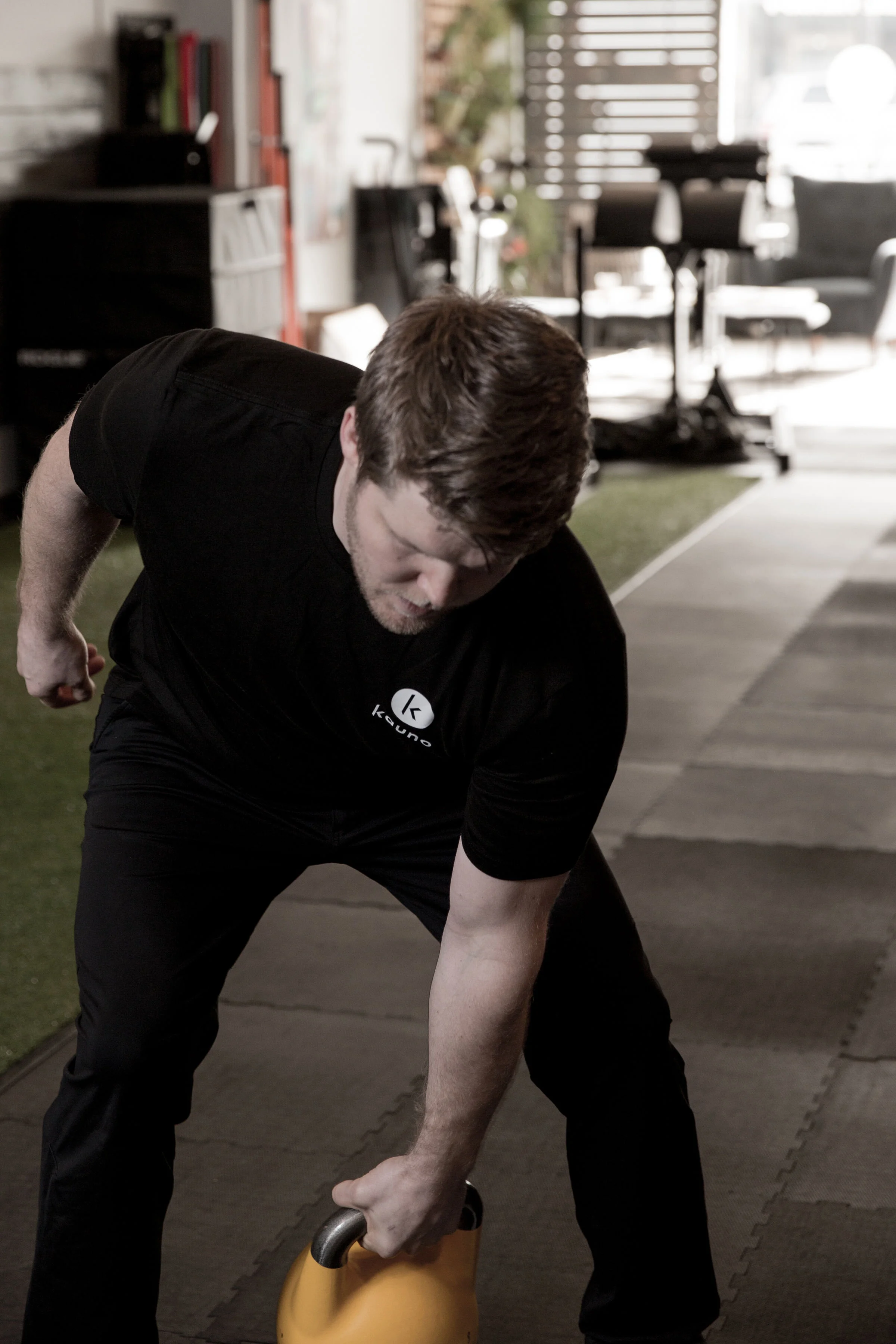Brian doing a single arm deadlift with a kettlebell