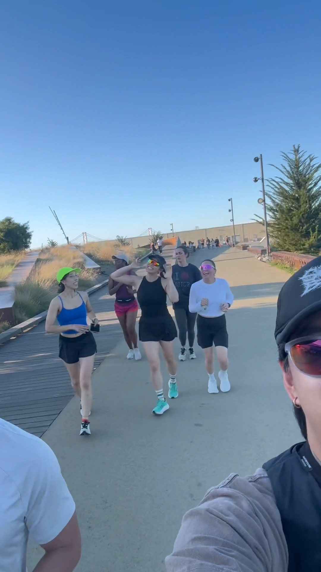 Post-Op Run Club members running together along the Embarcadero at golden hour