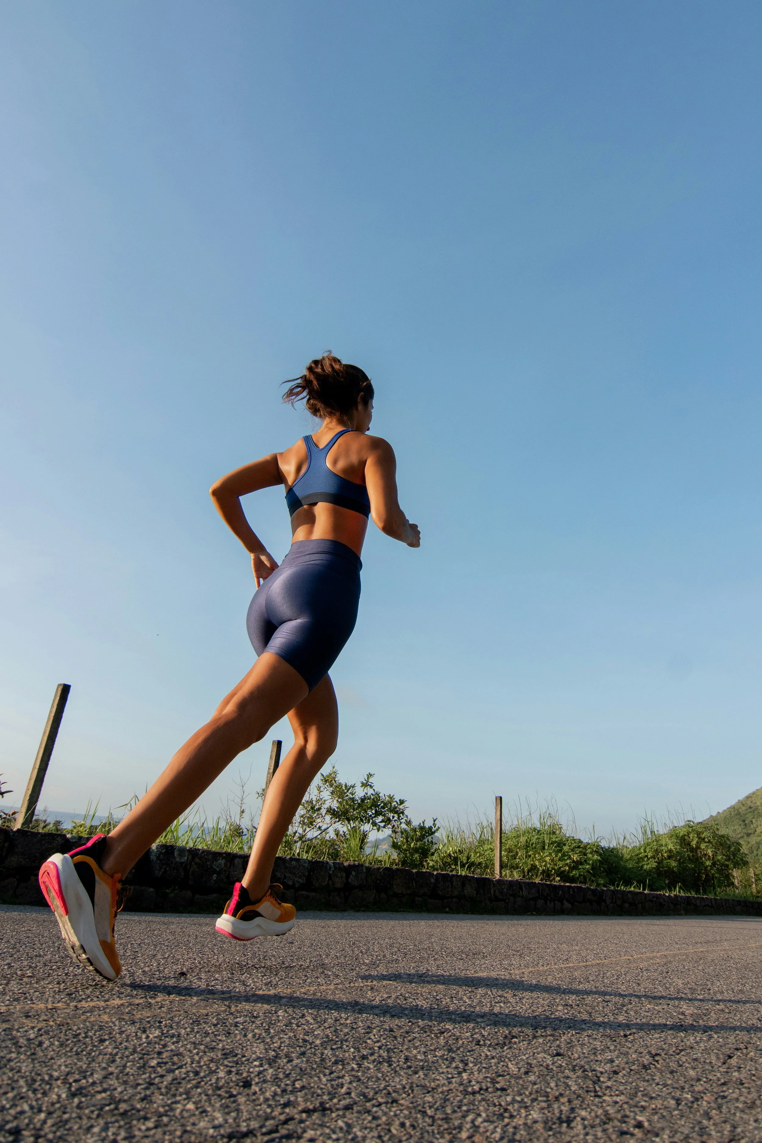 Runner on an empty road, illustrating bone stress injury prevention for runners.