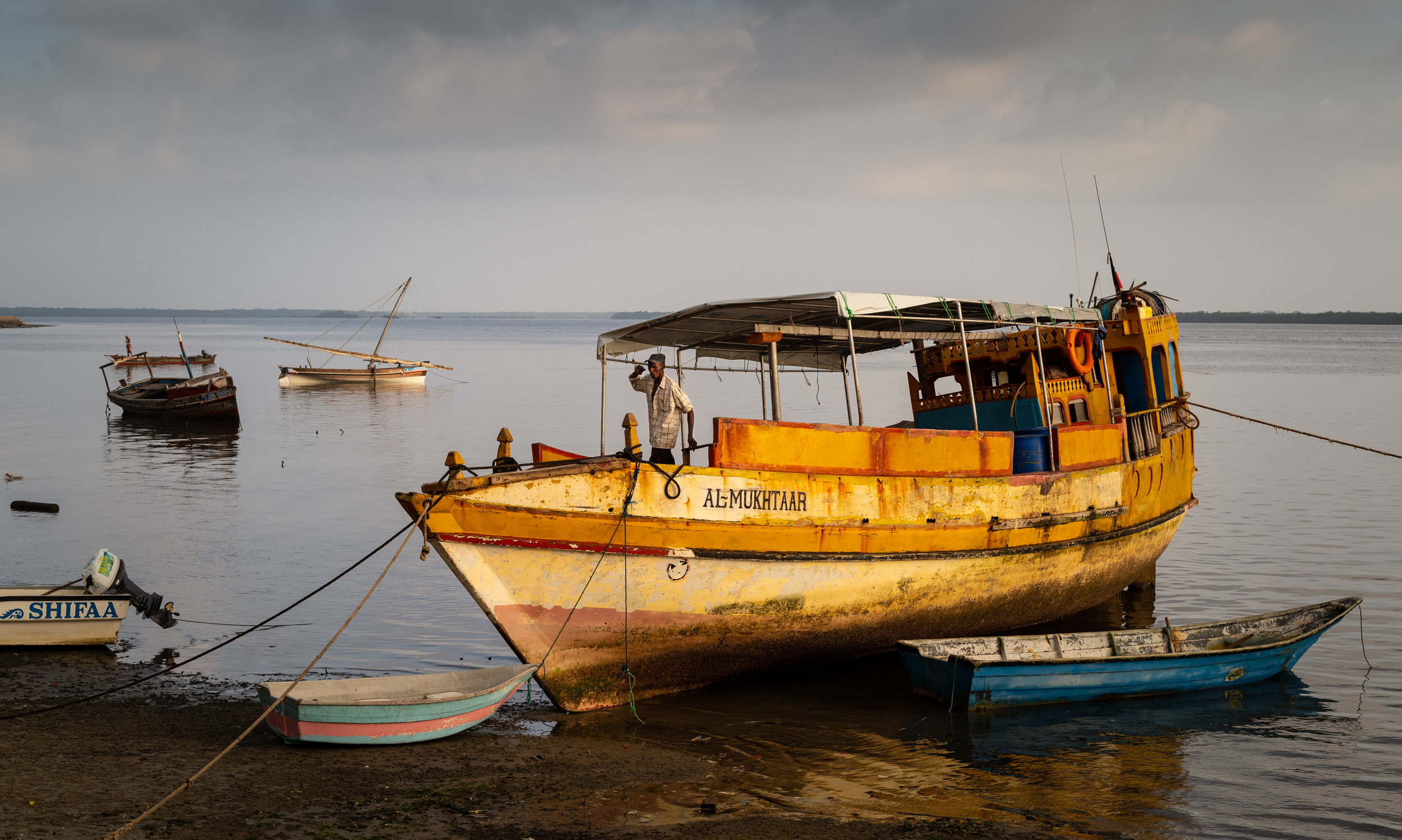 The al-Mukhtaar moored to the shore of Lamu, Kenya at low tide