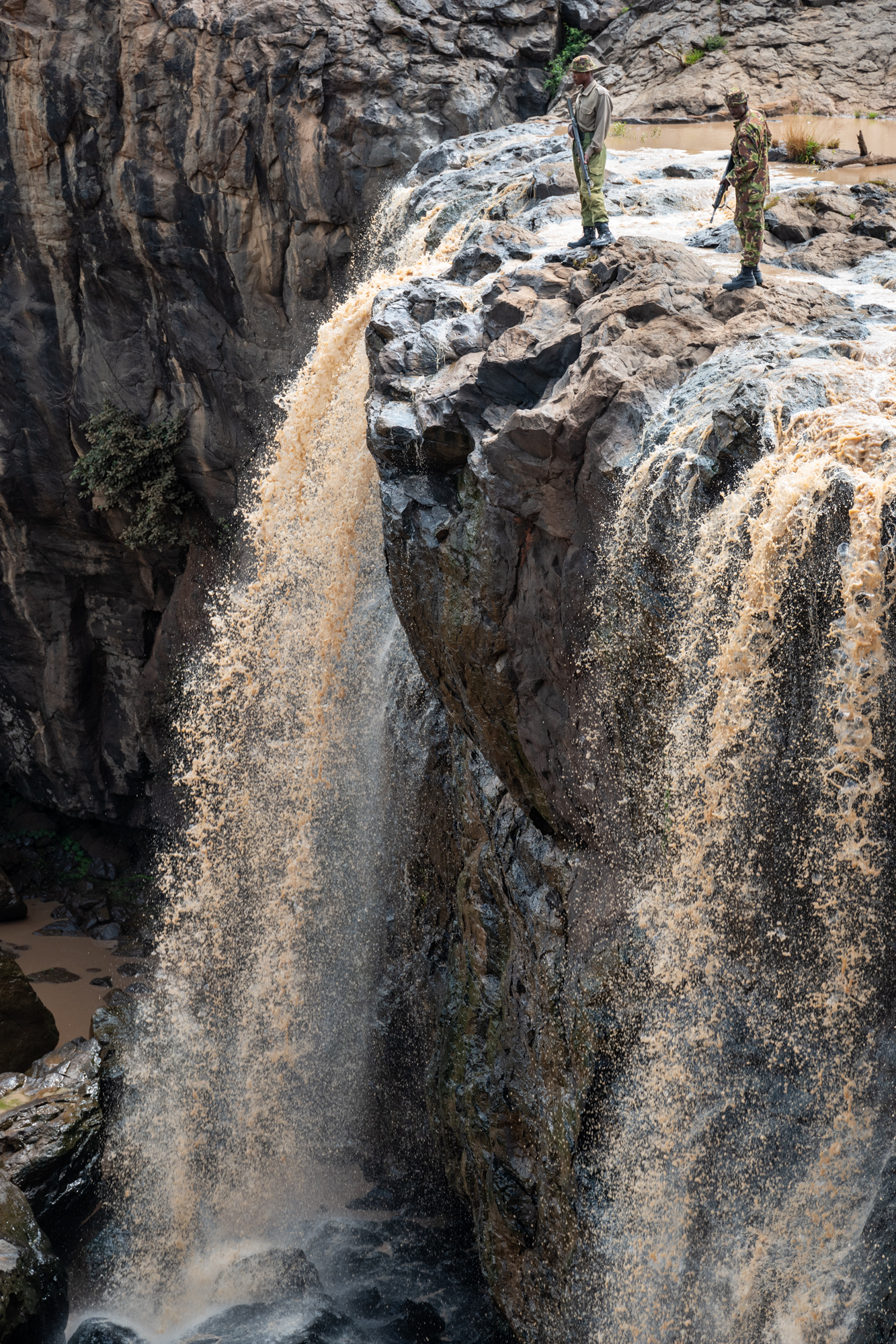 Wildlife rangers on patrol at a waterfall along the Ewaso Nyiro river on the El Karama Conservancy in the Laikipia region of Kenya