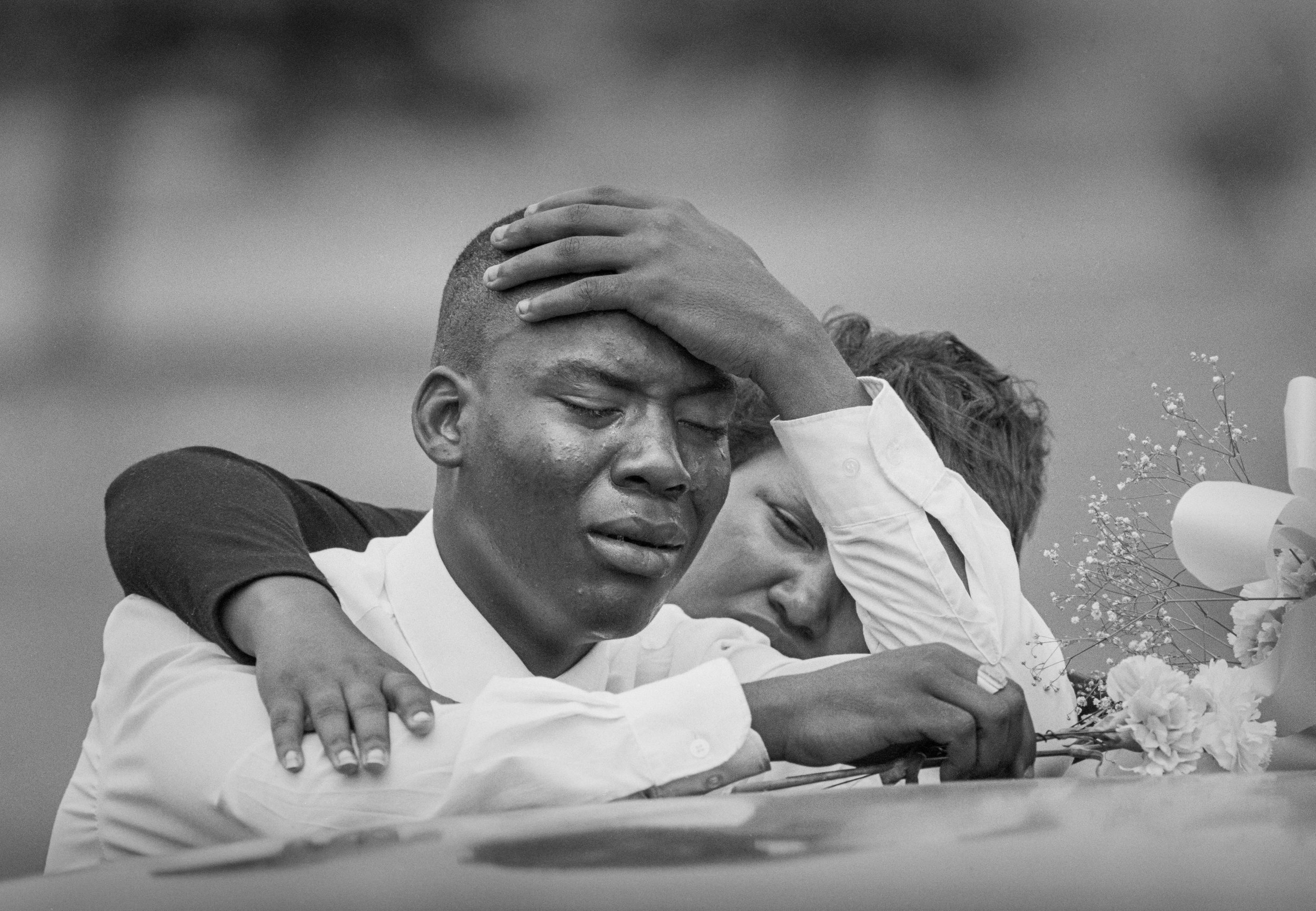 Tracee Steele is comforted by Angela Dickson at the coffins of Celena Lewis, 5, and Jahboa Lewis, 4, during funeral services at Evergreen Cemetery in Bedford Heights, Ohio