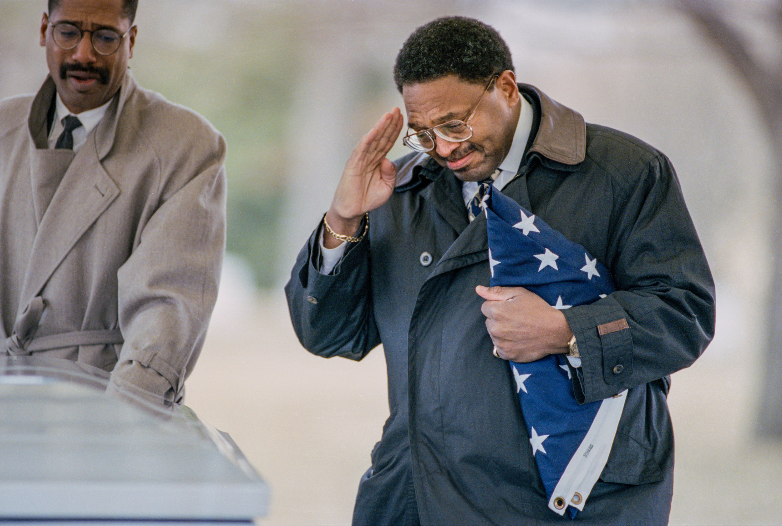 John Porter salutes the casket of his son, Marine Corps Lance Corporal Christian Porter, during funeral services at Camp Butler National Cemetery in Springfield, Illinois