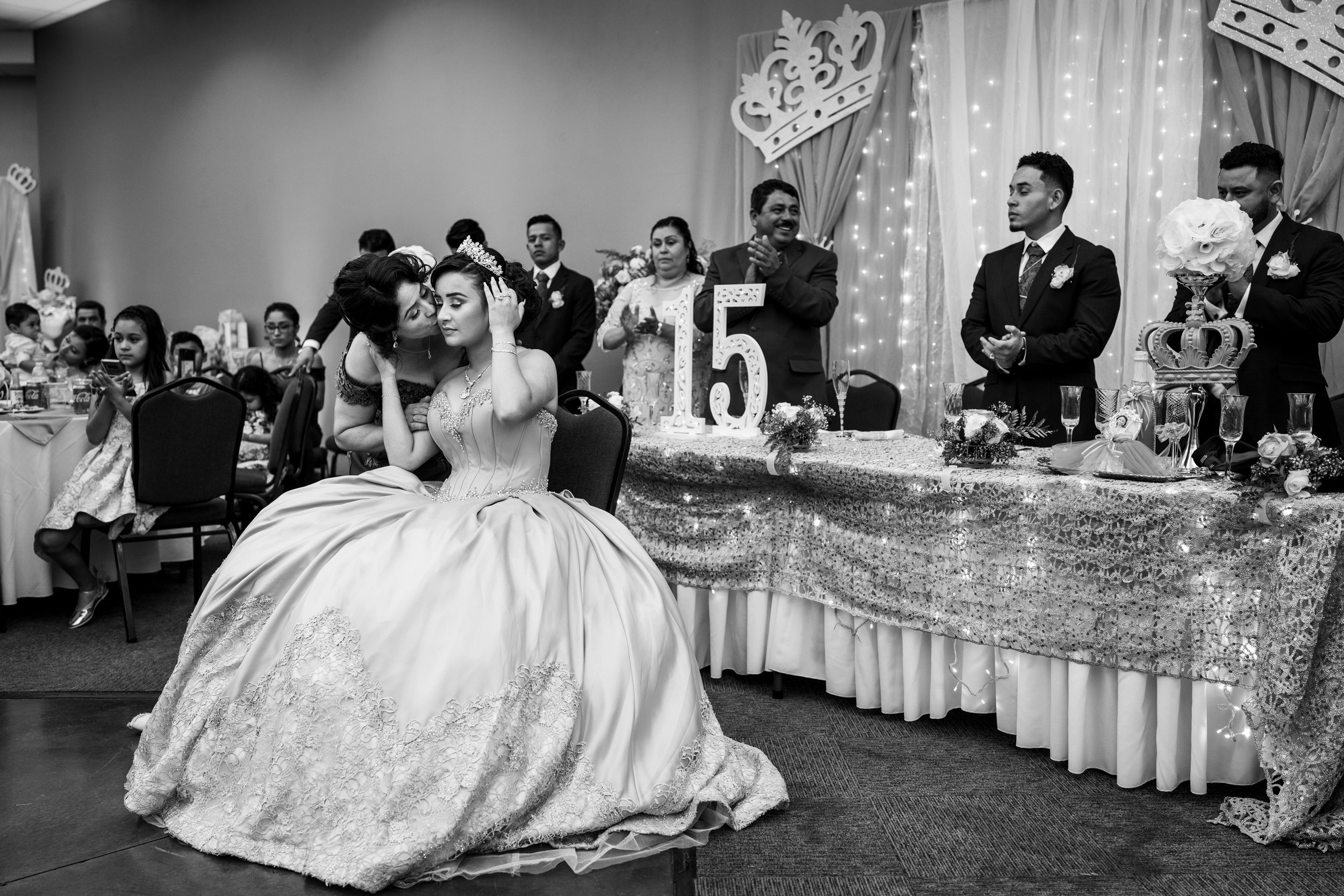 Telma Hernandez kisses her daughter Adriana Gonzalez after crowning her with a tiara during Adriana’s quinceañera in Sacramento, California