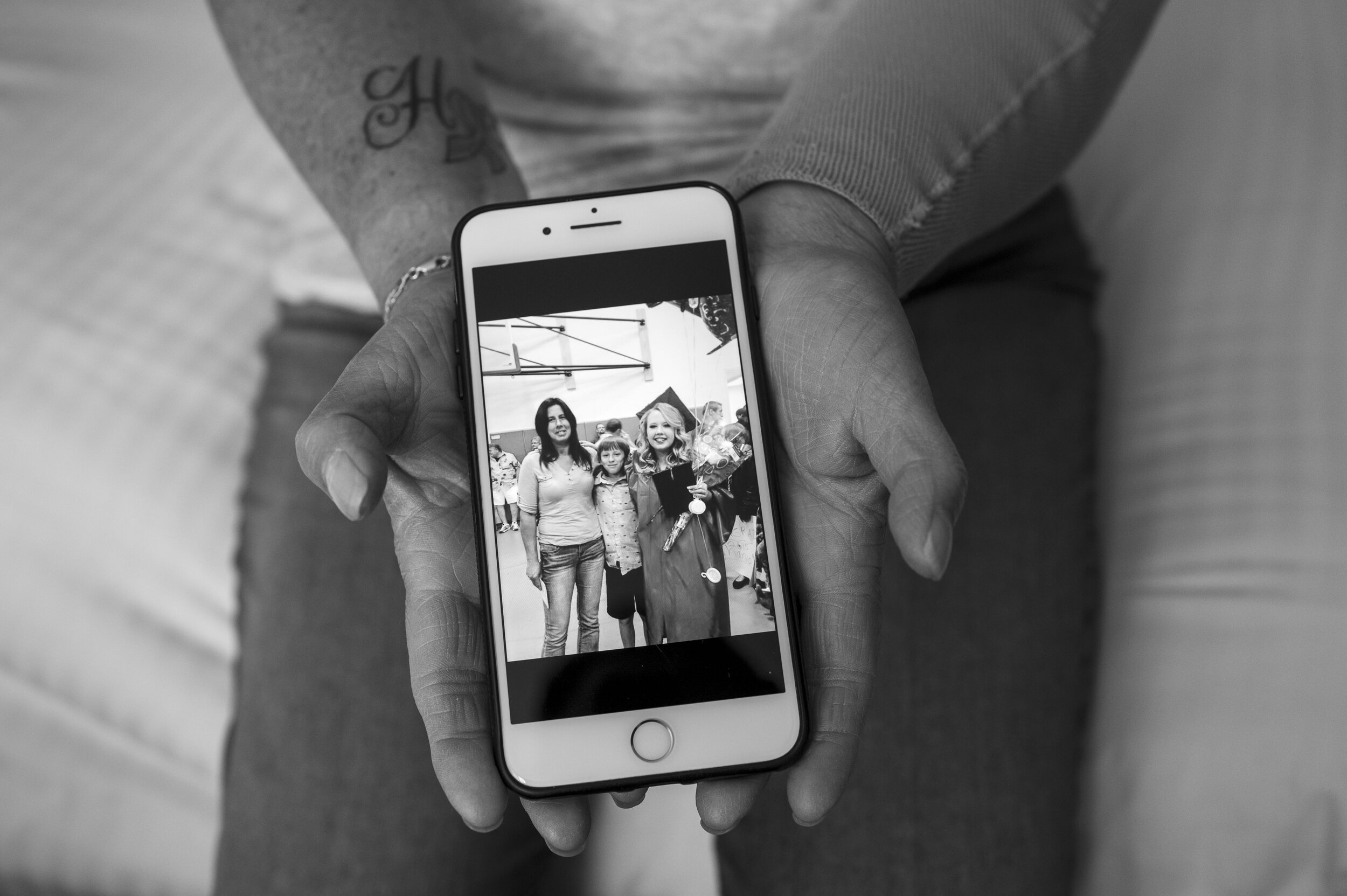 Sandy Holden keeps a picture of herself before breast cancer with her son Jimmy Lopez and daughter Shania Lopez on her phone