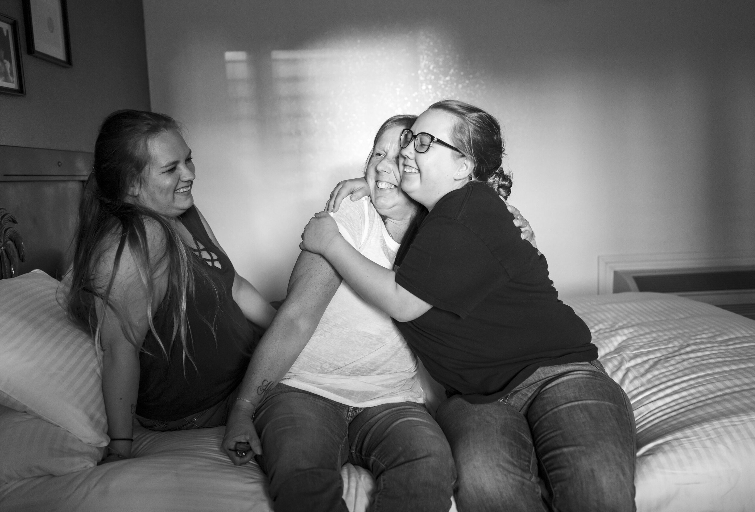 Sandy Holden and her daughters Tymika Lopez, left, and Shania Lopez, right, in a motel in Sacramento, California the night before Sandy’s breast reconstruction surgery