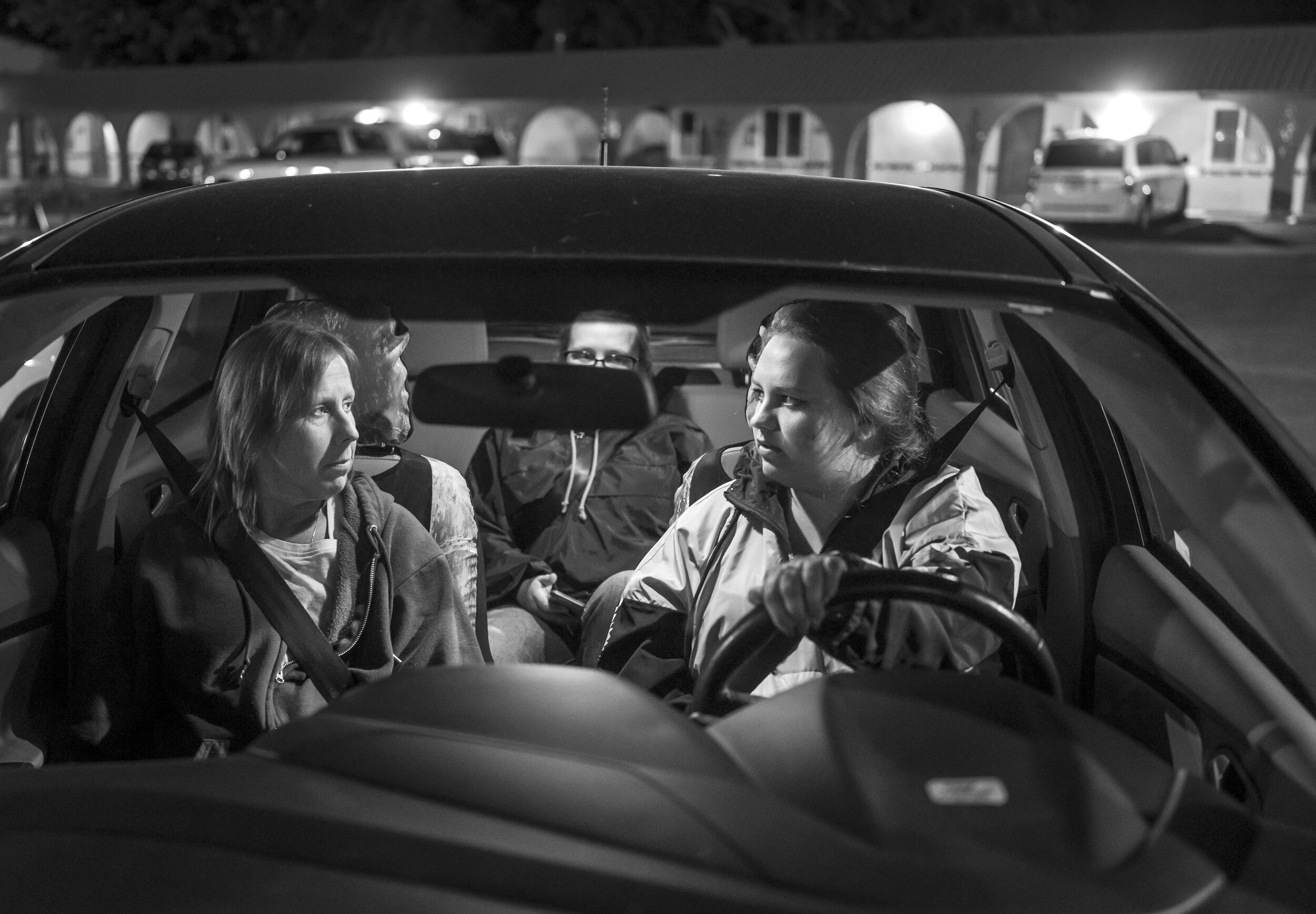 Sandy Holden and her daughters Tymika Lopez and Shania Lopez in their car in a motel parking lot in Sacramento, California
