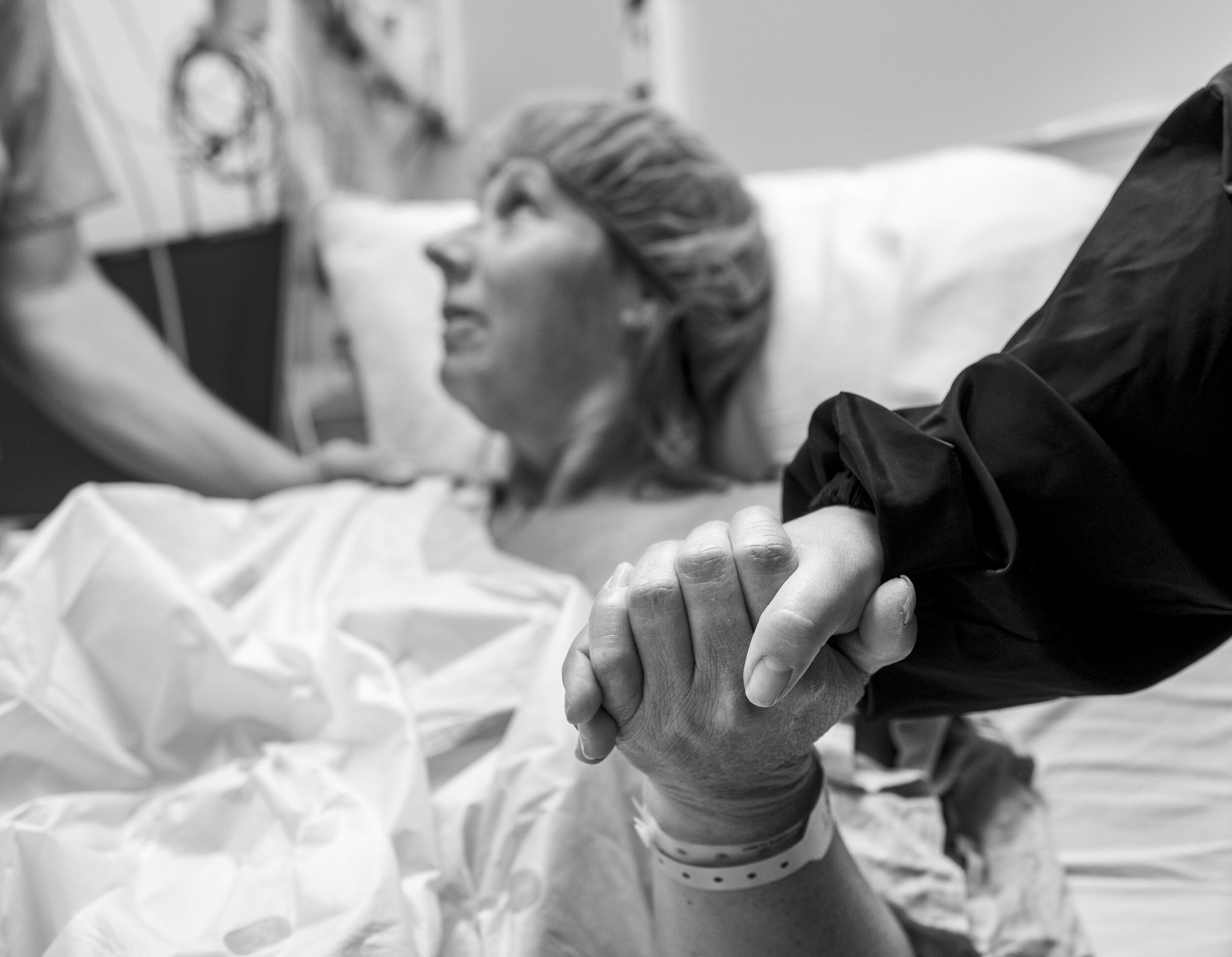 Sandy Holden holds her daughter Shania Lopez’s hand just before Sandy’s breast reconstruction surgery at the UC Davis Medical Center in Sacramento, California