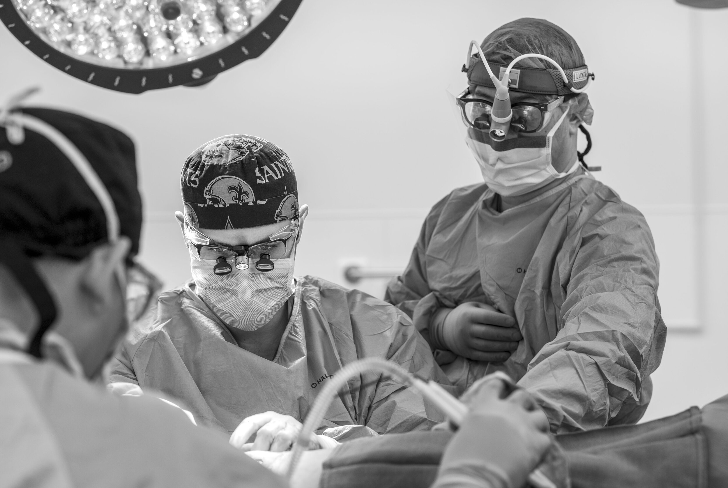 Dr. Charleston Chua, left, Dr. Heath Charvet, center, and Dr. Michael Wong, right, perform Sandy Holden’s breast reconstruction surgery at the UC Davis Medical Center in Sacramento, California