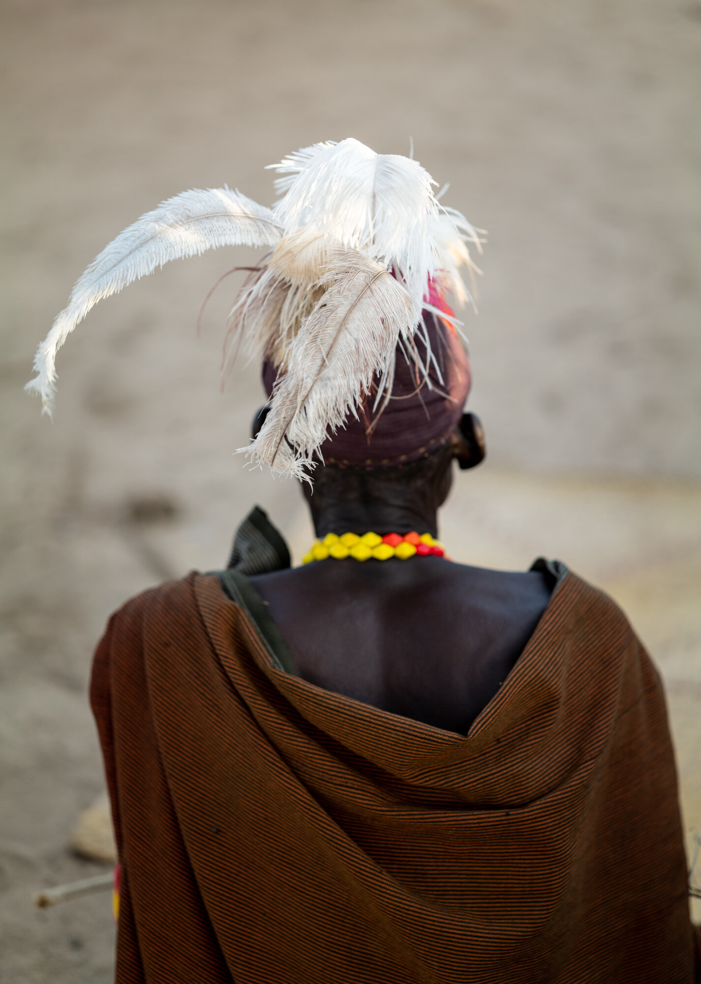 Ostrich feathers adorn the headdress of a Turkana man on the shore of Lake Turkana in Kenya