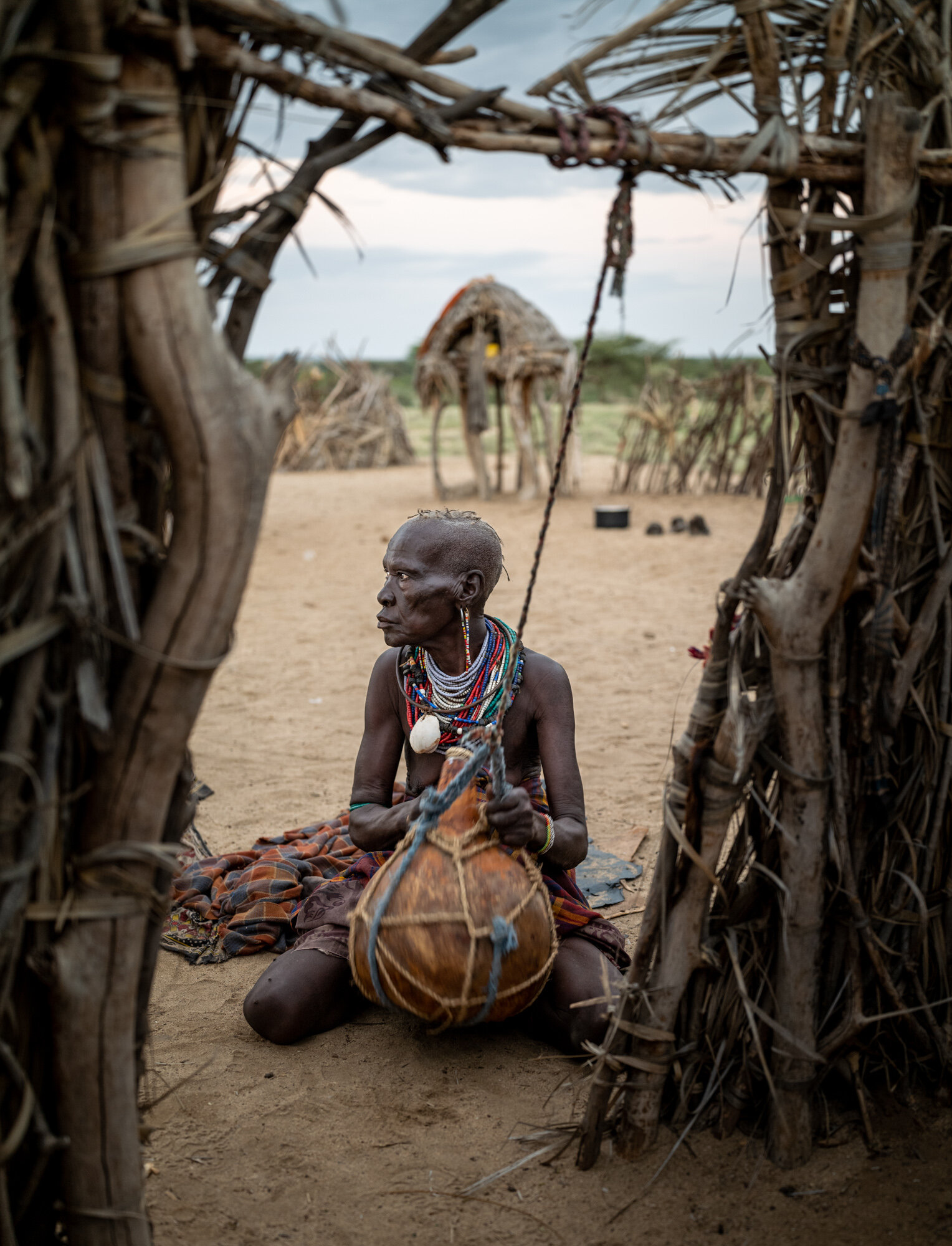 Lepo Ikal makes butter from goat milk in a gourd at her family’s home on the shore of Lake Turkana in Kenya