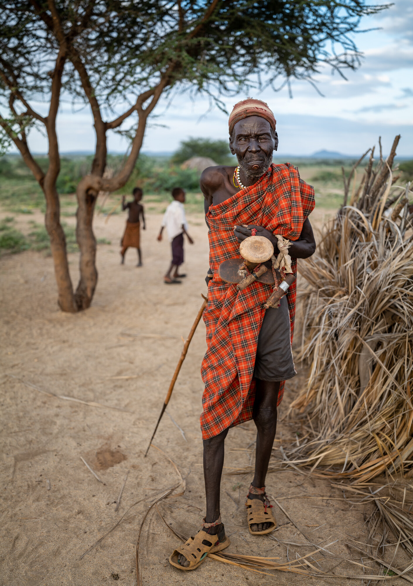 Ekoel Kure with his stave and ekicholong on the shore of Lake Turkana in Kenya