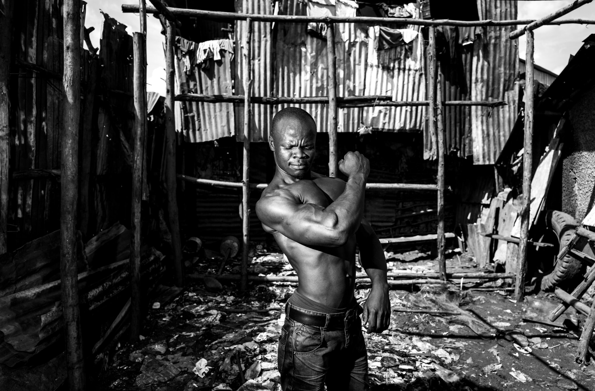 Bodybuilder Jim Odinga in his makeshift gym in the Kibera slum in Nairobi, Kenya