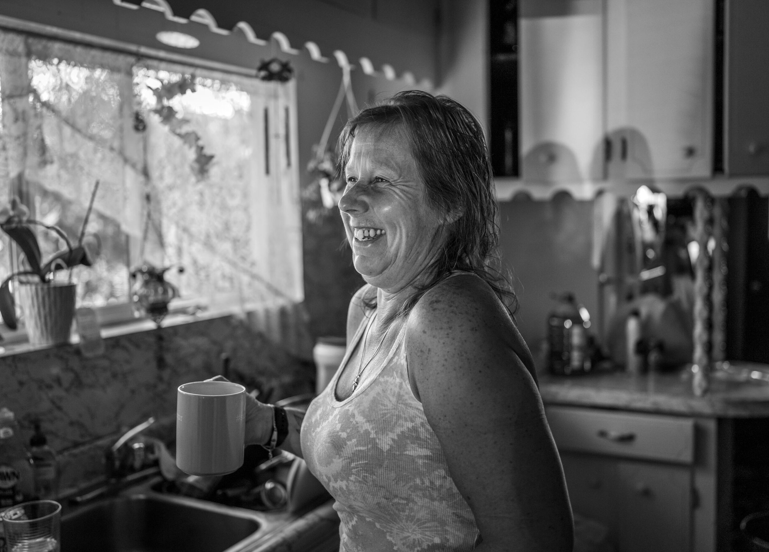 Sandy Holden enjoys a cup of coffee and a laugh with her family in the kitchen of her home in Westwood, California after Sandy recovered from breast cancer and breast reconstruction surgery