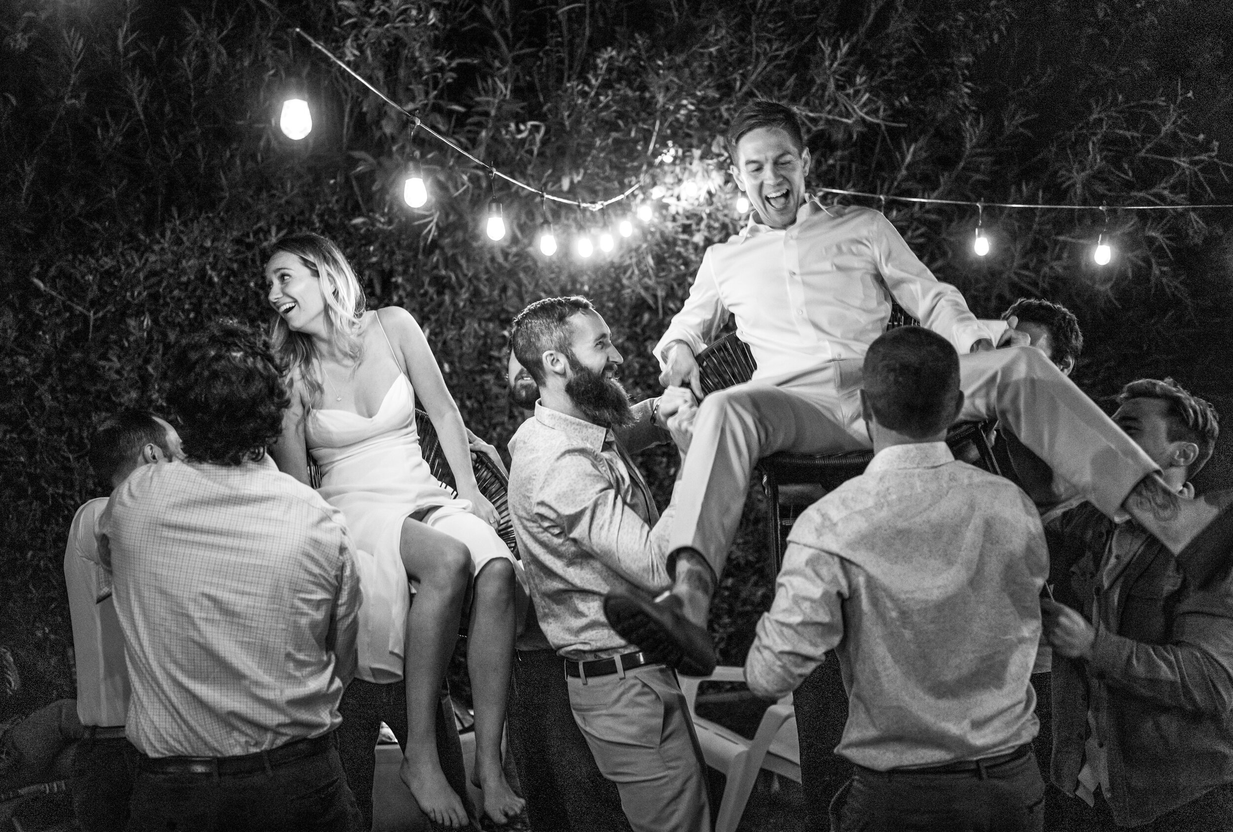 Jill and Dante Macissos are hoisted aloft during their backyard wedding in Sacramento, California.