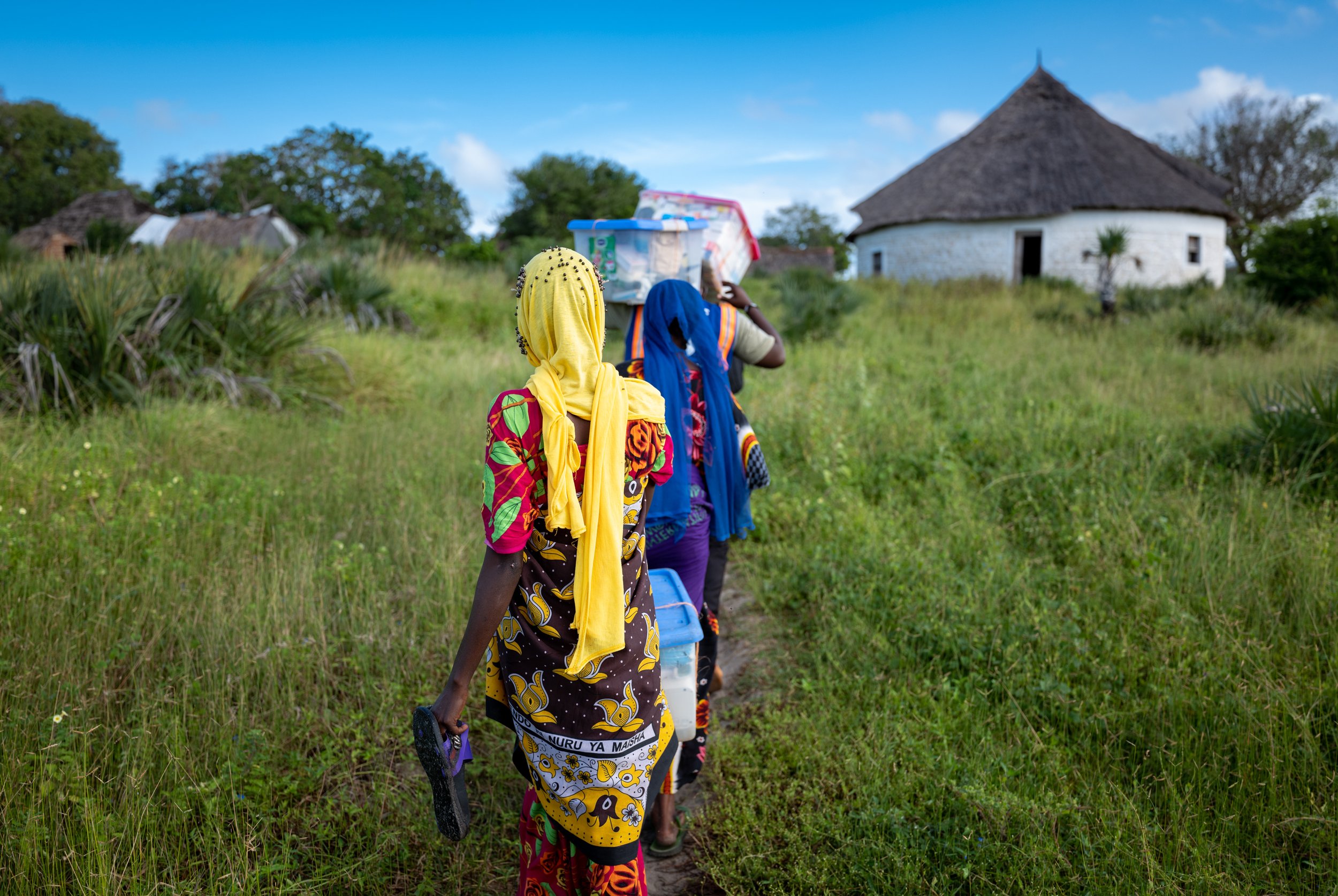 Salama Bakari, Posho Mohammed and Shanga Nzole carry medicines ashore to the Safari Doctors clinic in the village of Kiangwe, Kenya