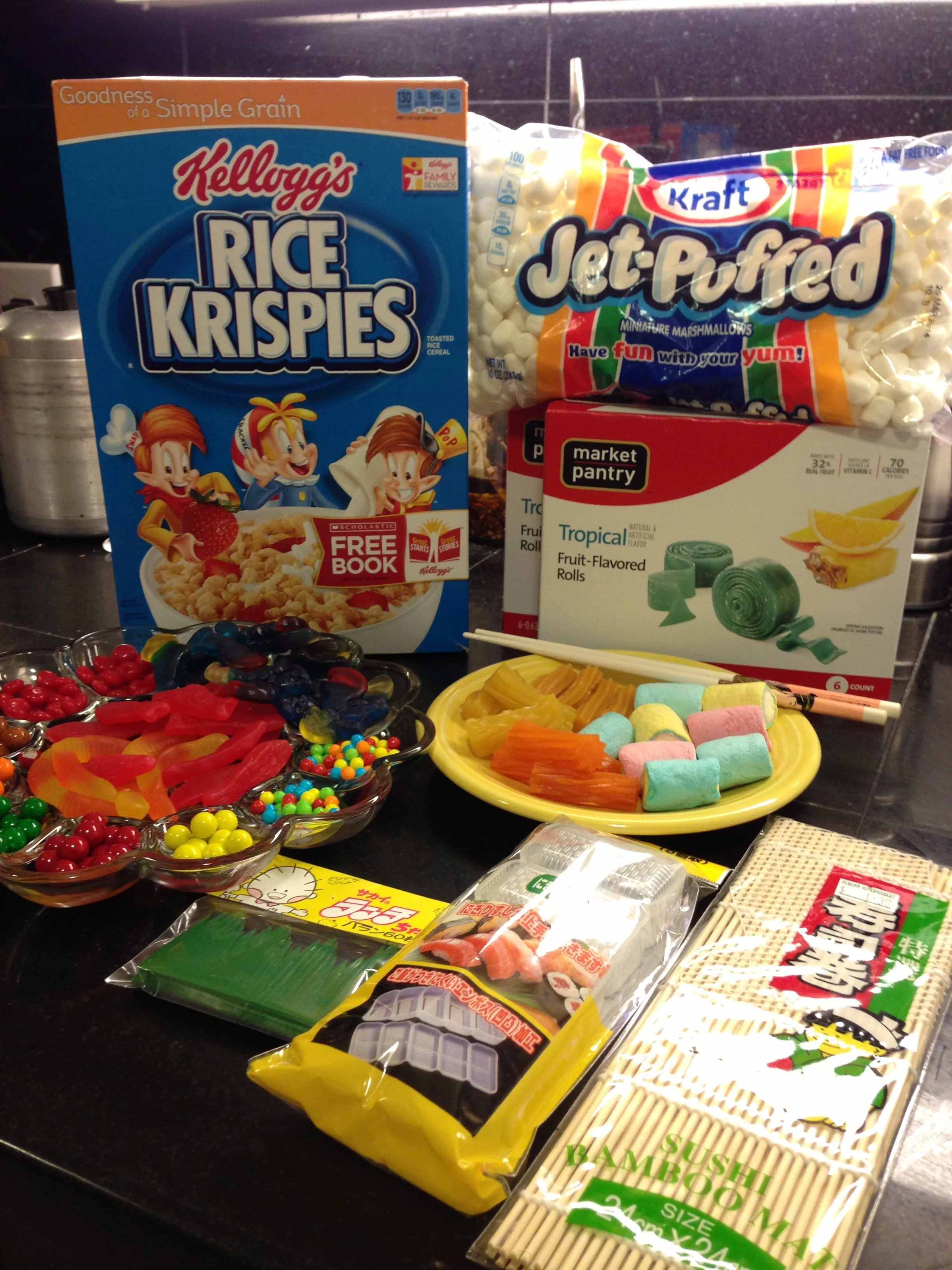 Cereal, marshmallows, candy, and implements of assembly.