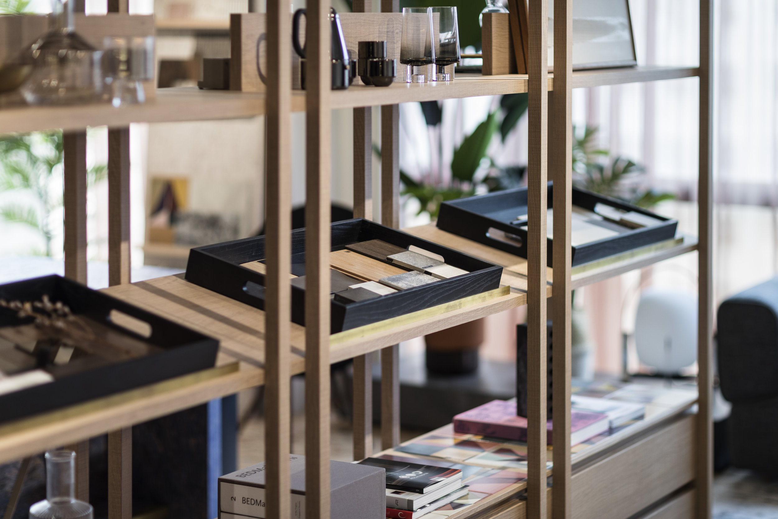  OFFICE / 2018  The open-plan office integrates casual fun through simple materials. Black wood panelling became a main backdrop of the office as well as hiding the facilities behind. The open shelves cum material tray holder acts as a separation scr