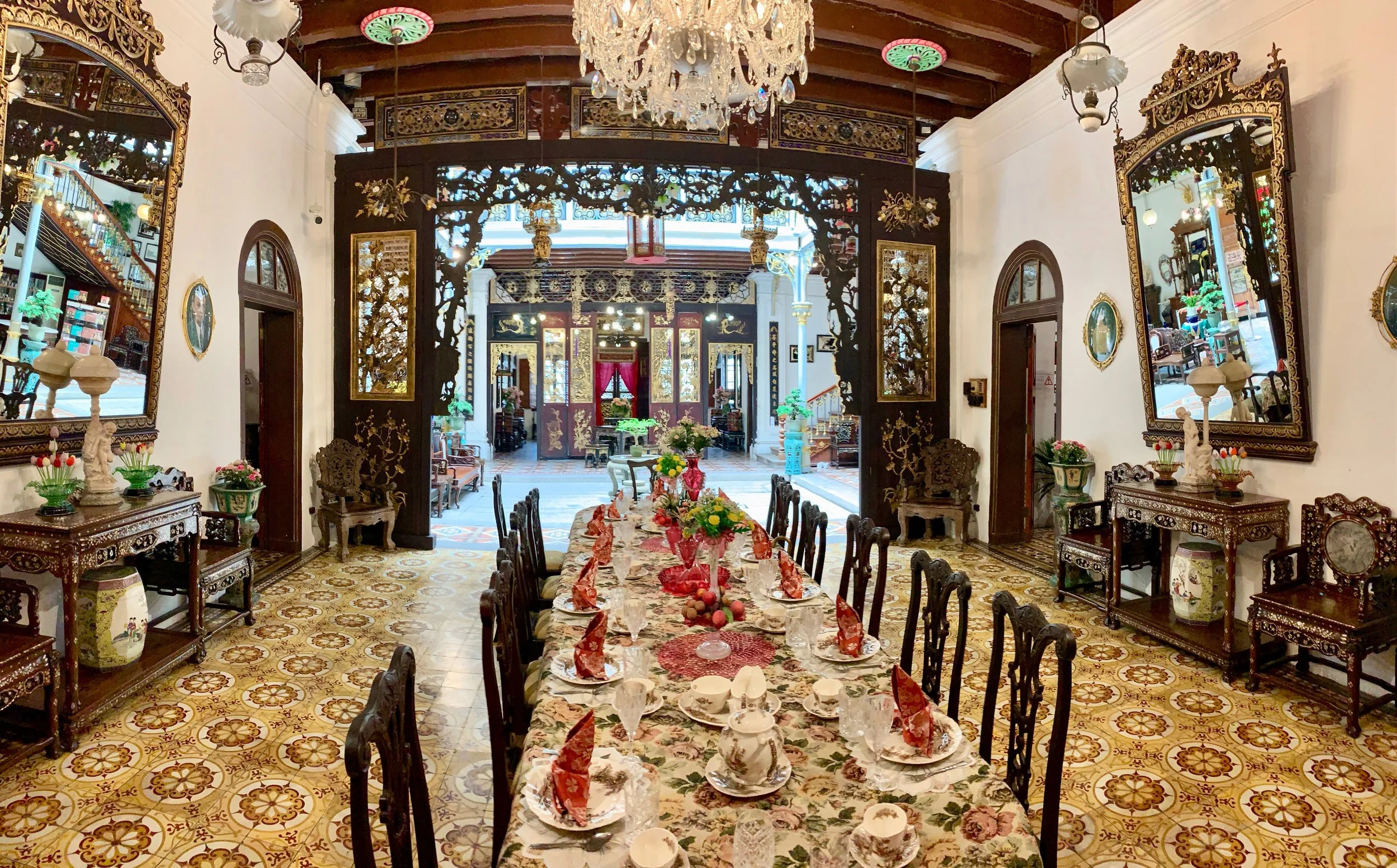Formal dinning room, looking toward the interior courtyard. The style of tile is traditional Peranakan.
