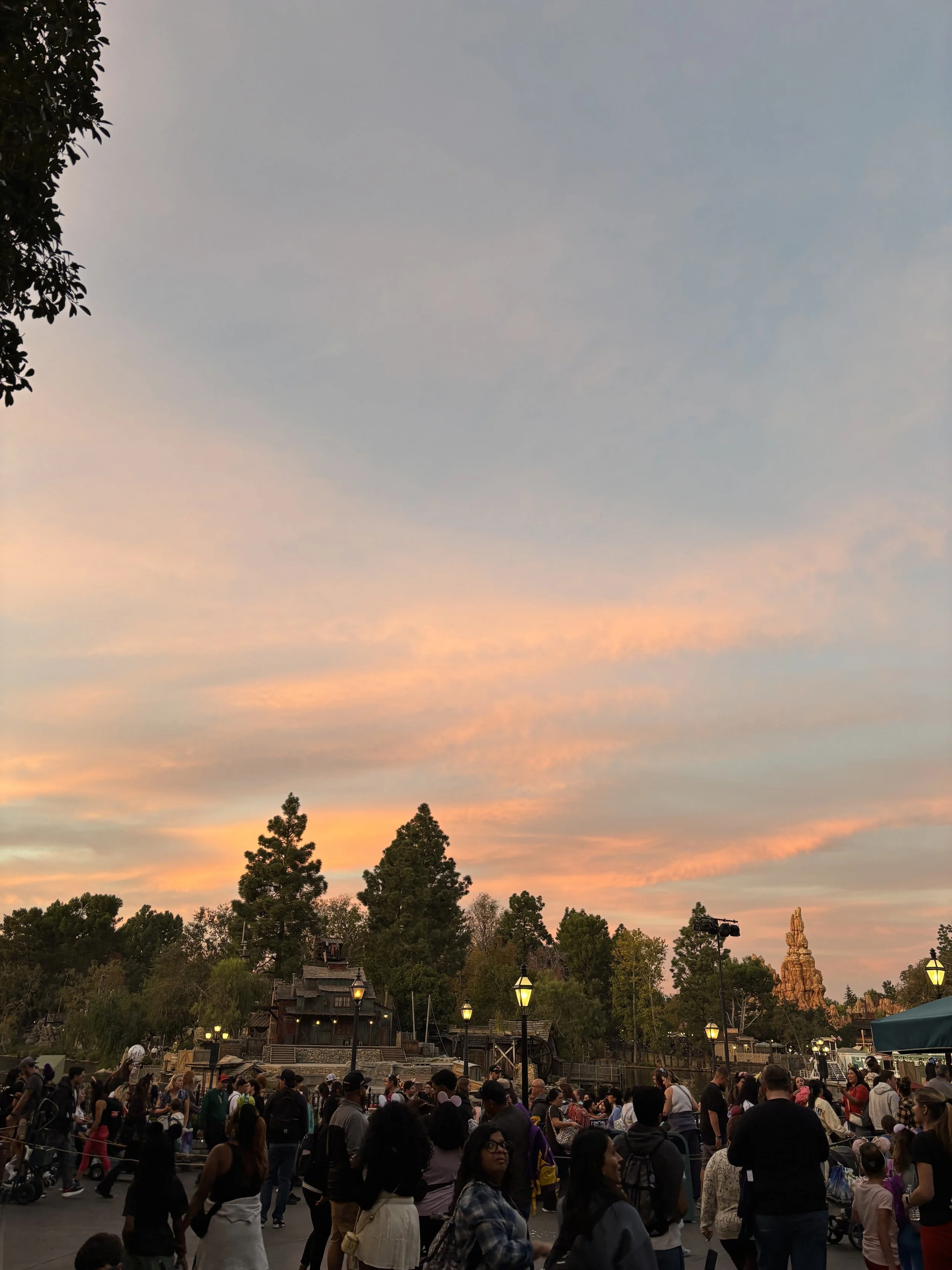 A view of the Rivers of America in New Orleans Square in Disneyland. The sunset reveals golden pink and blue hues.