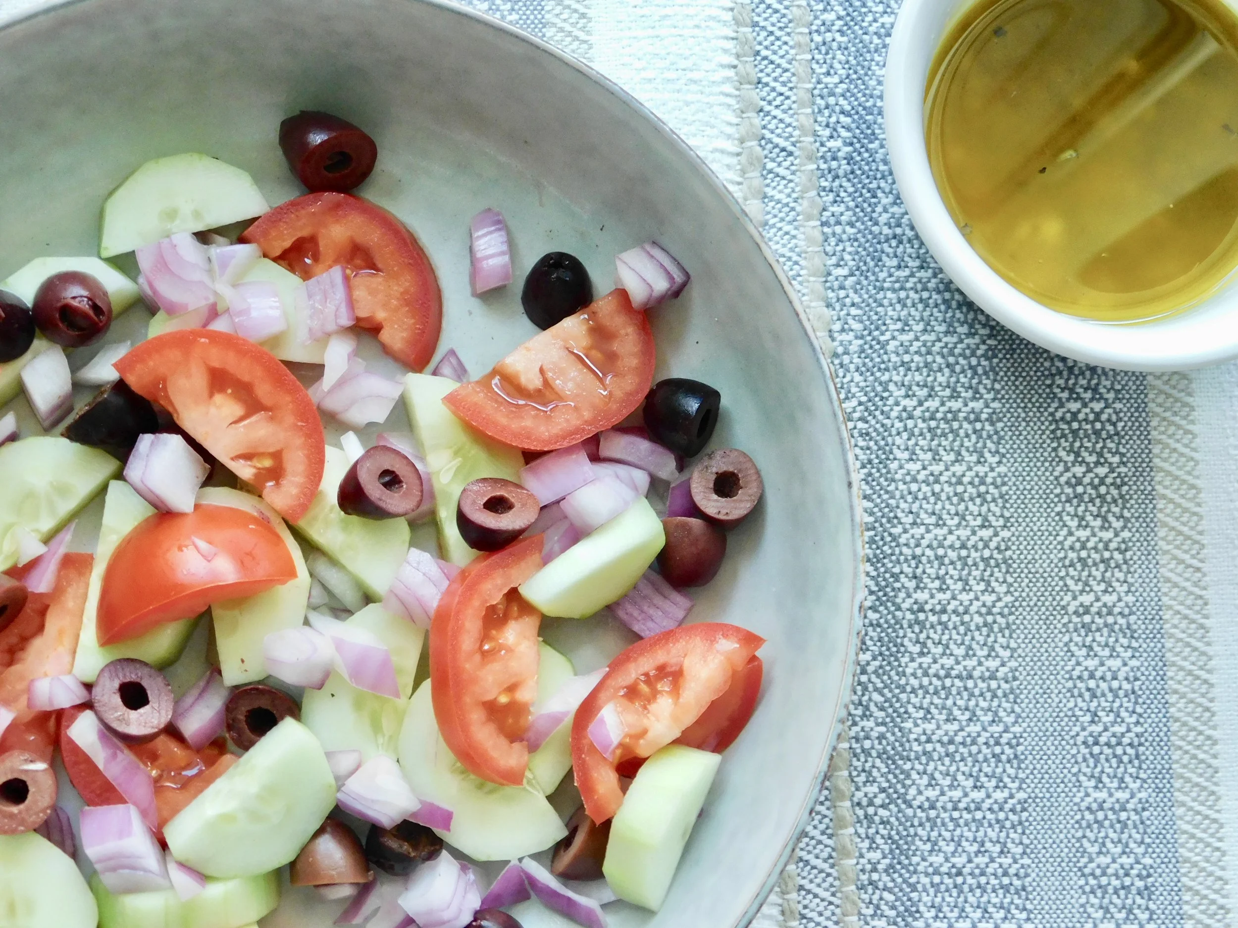 Greek salad served with vinaigrette dressing