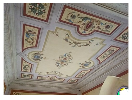 At the top of the stairs is a beautiful ceiling fresco
