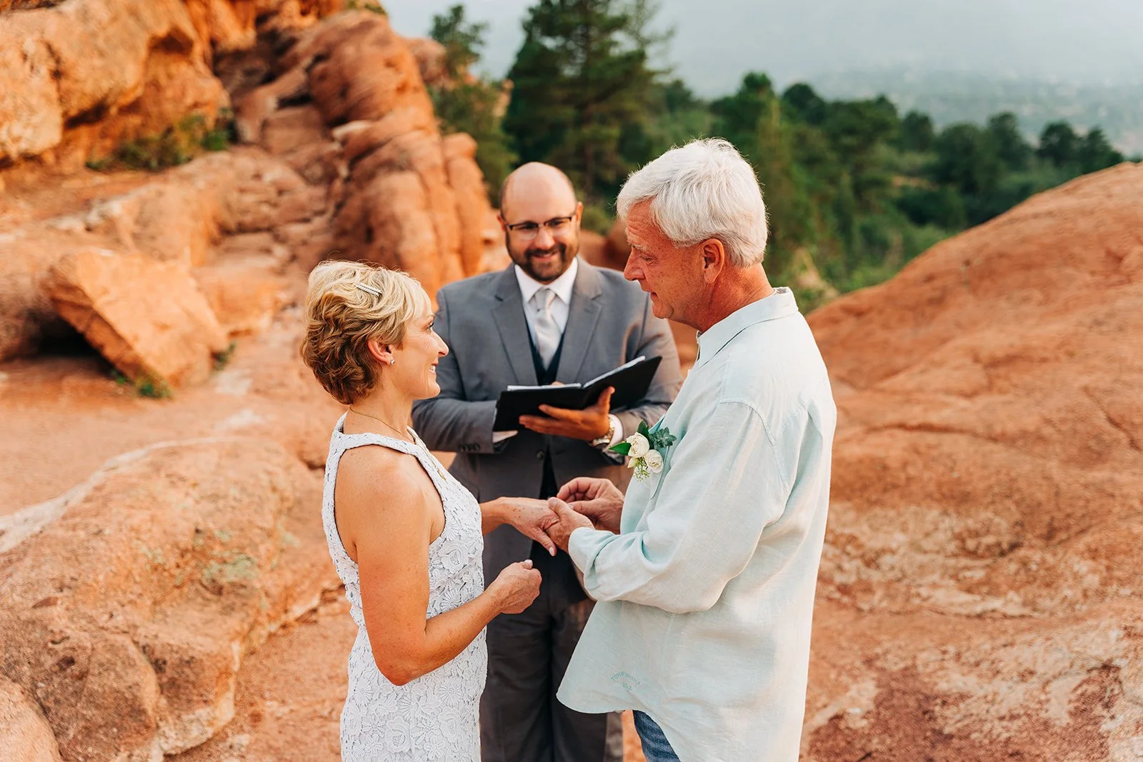couple having a beautiful wedding ceremony in garden of the gods colorado springs