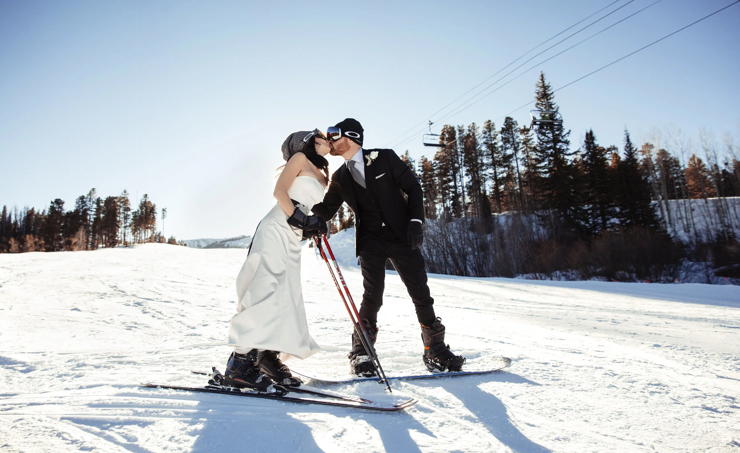 couple having a snowboard wedding in colorado