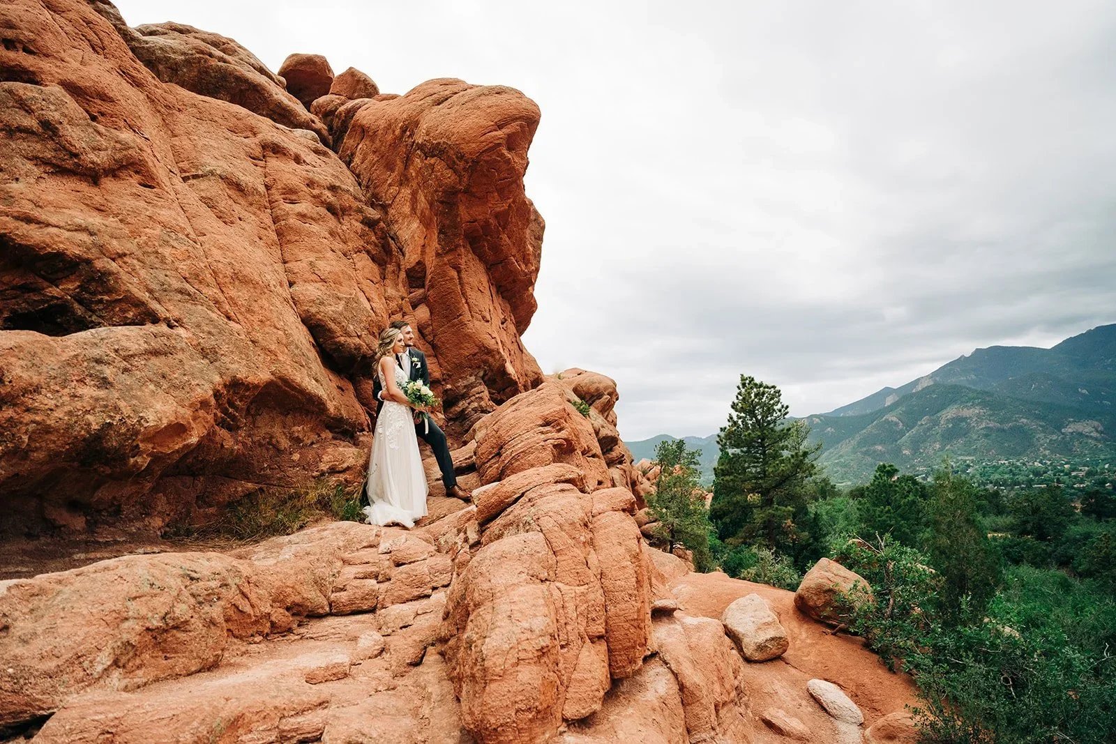 garden of the gods elopement in colorado with bride and groom watching sunrise