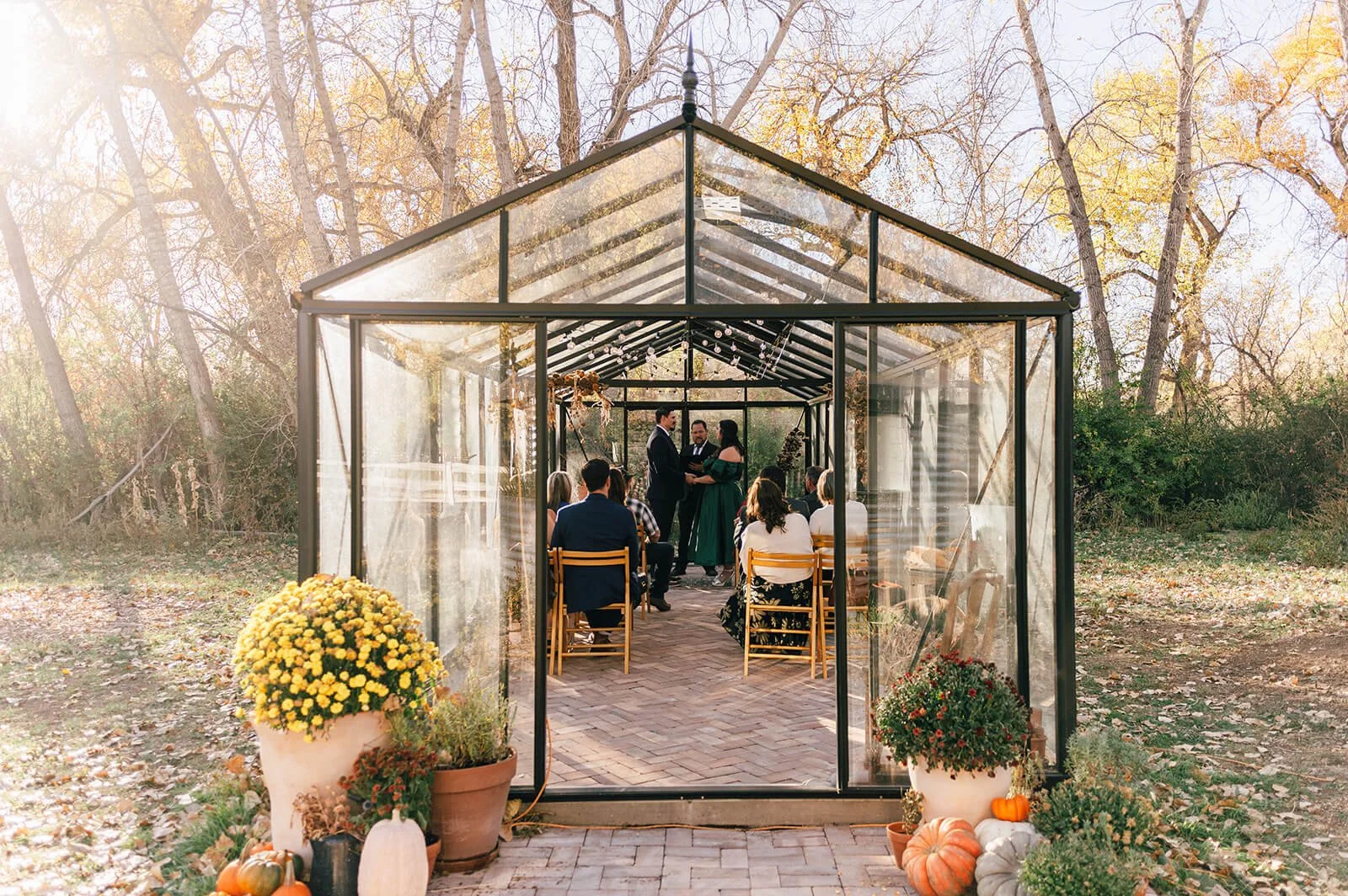 colorado small wedding at yetmans farms in denver colorado in a greenhouse during fall with fall colors.