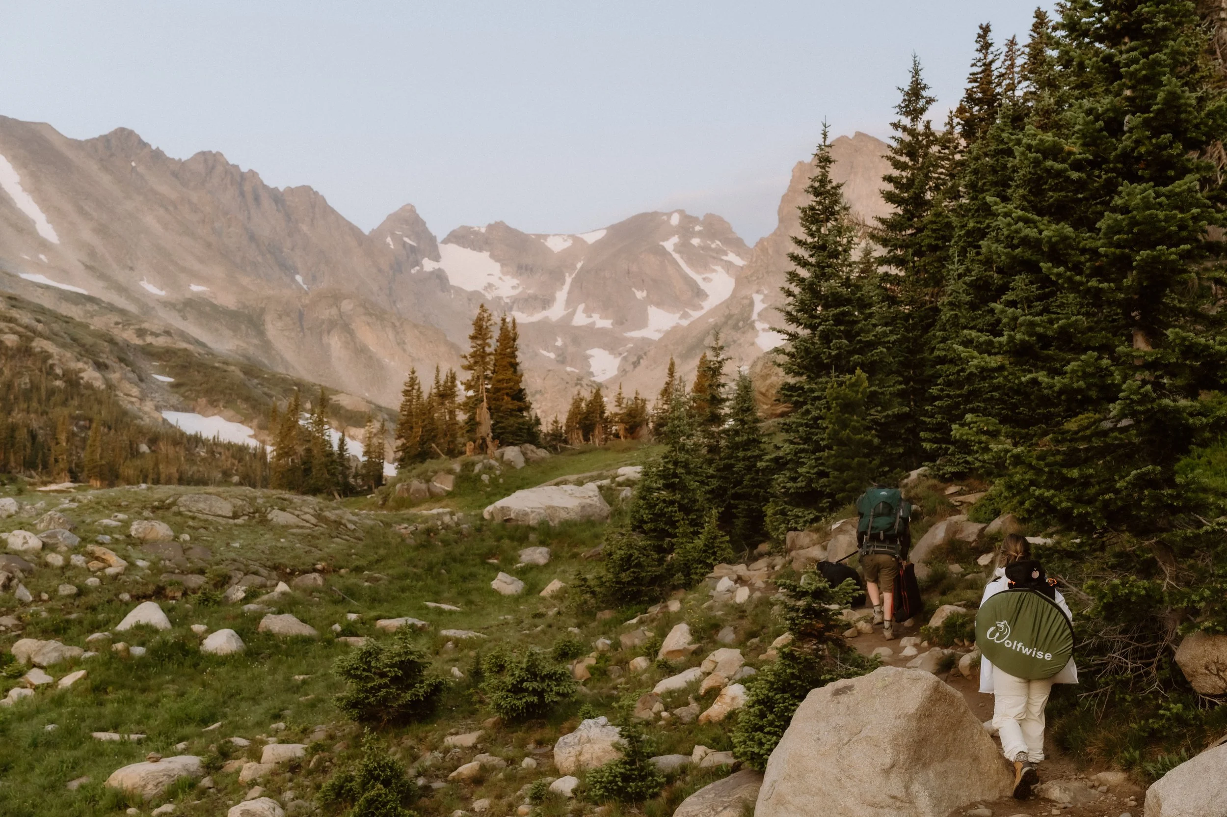 couple hiking toward their colorado elopement lake isabelle