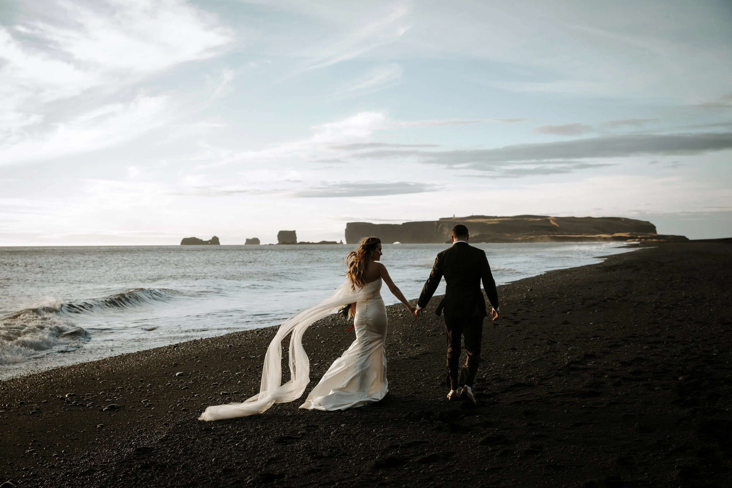adventure wedding in iceland, couple walking on beach