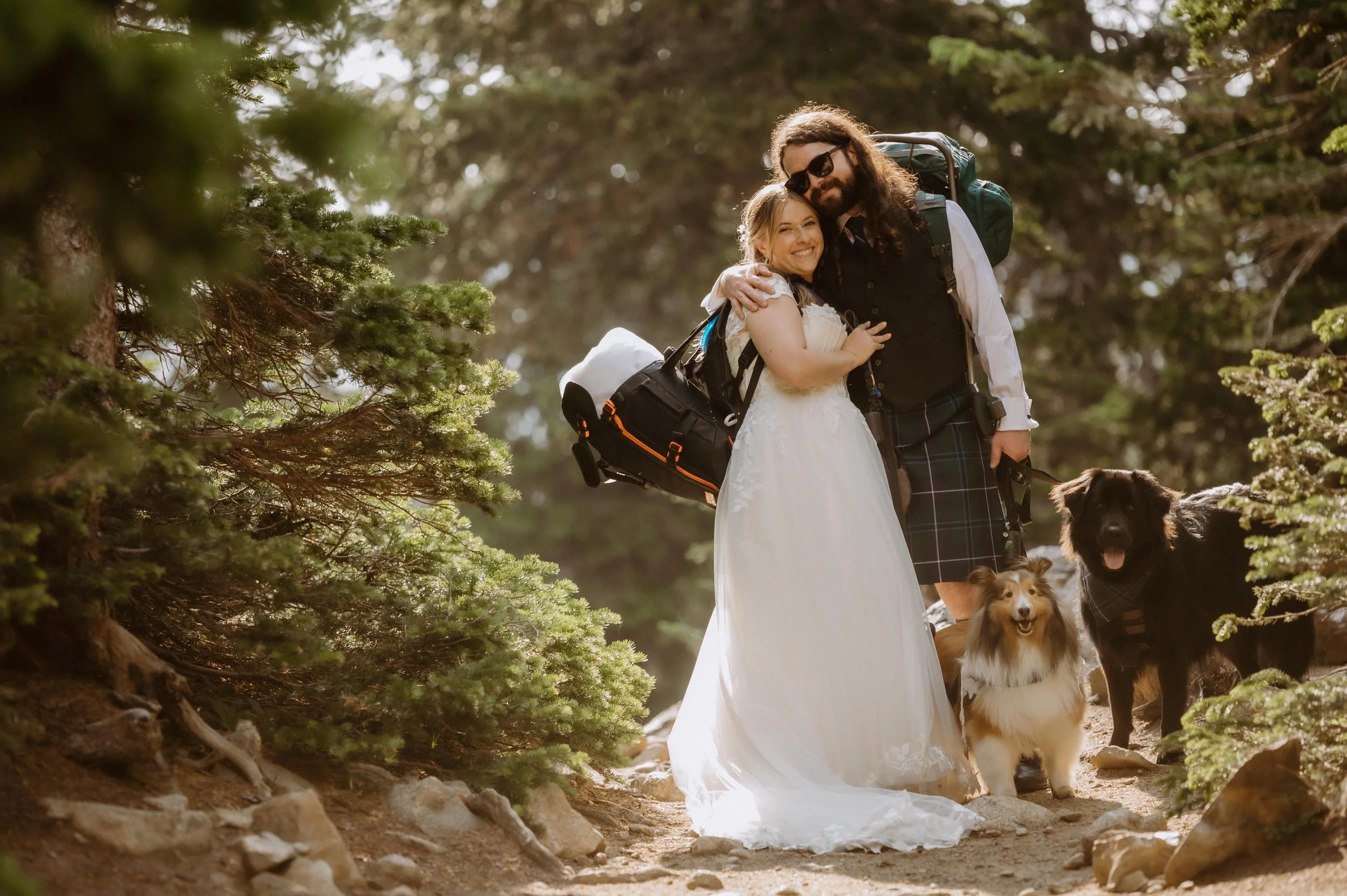couple posing with their dog for an elopement hike lake isabelle