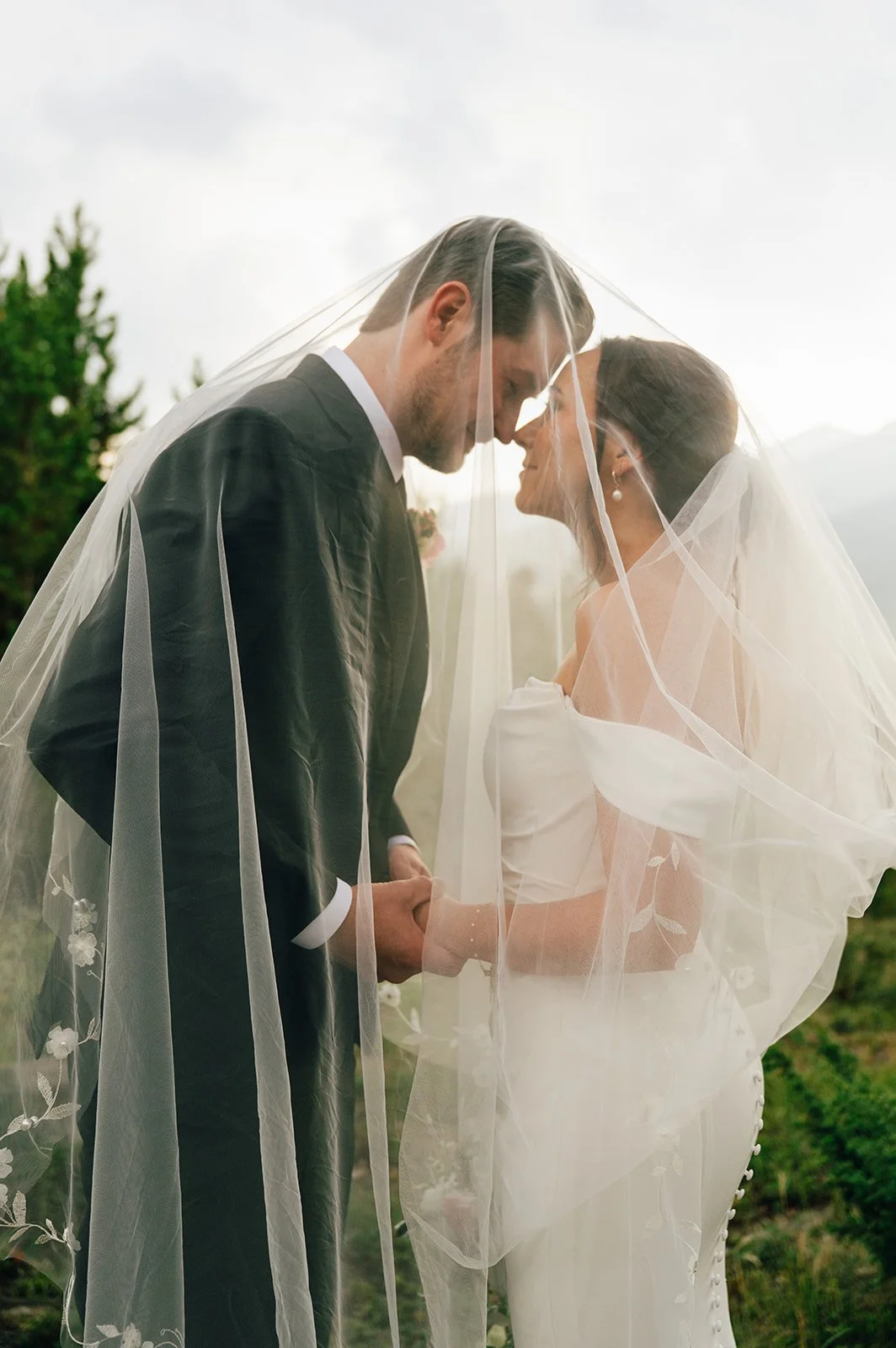 bride and groom taking photos after their elopement at officer's gulch at sunrise