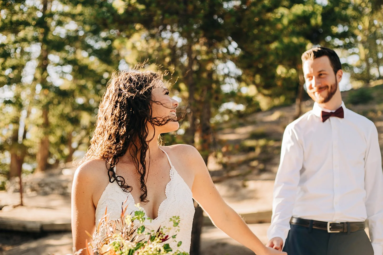 rocky mountain national park couple posing for photos after their sunrise wedding ceremony near sprague lake