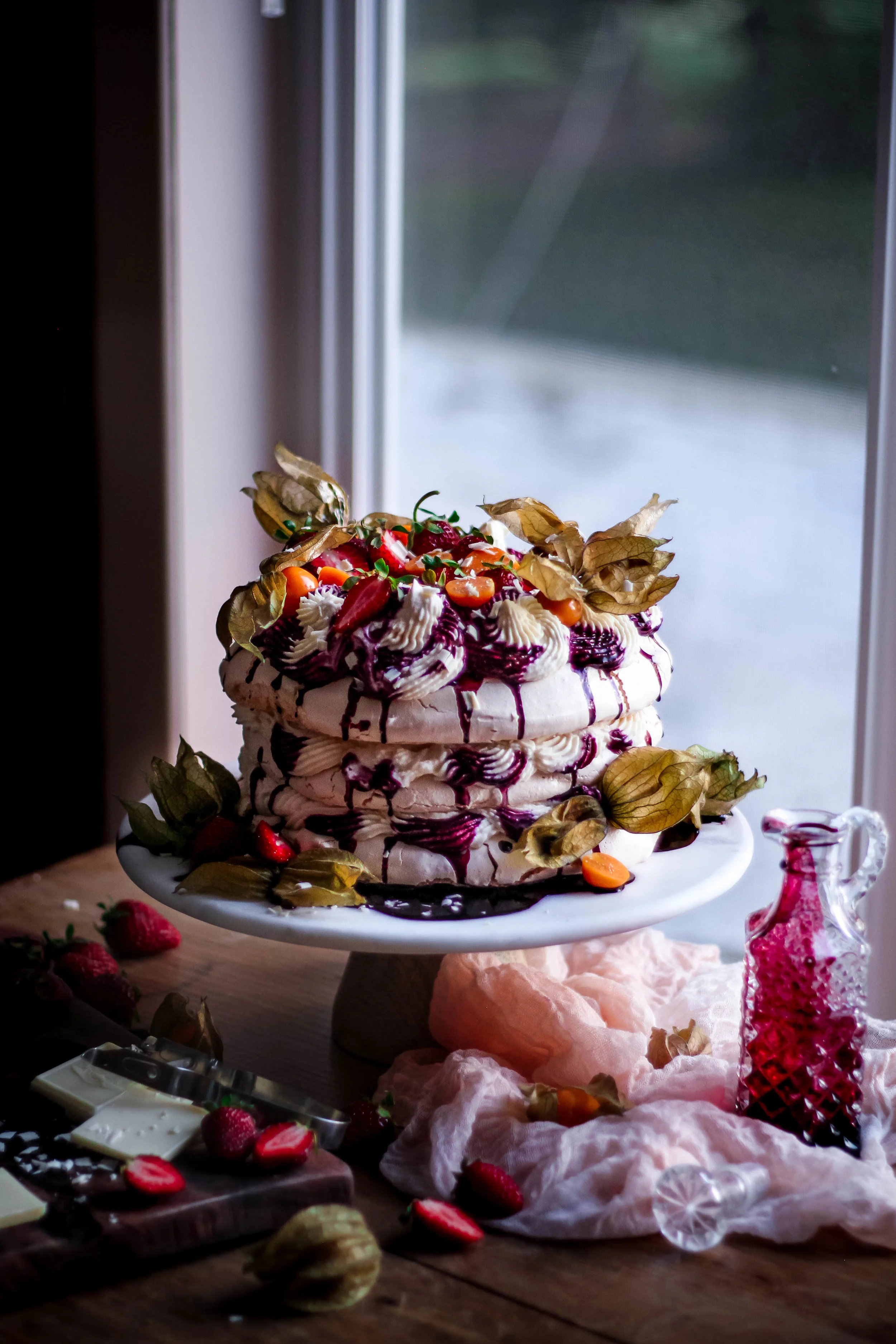 Pavlova with Vanilla Bean Mascarpone Cream, Seasonal Berries, and Black Raspberry Rose Coulis