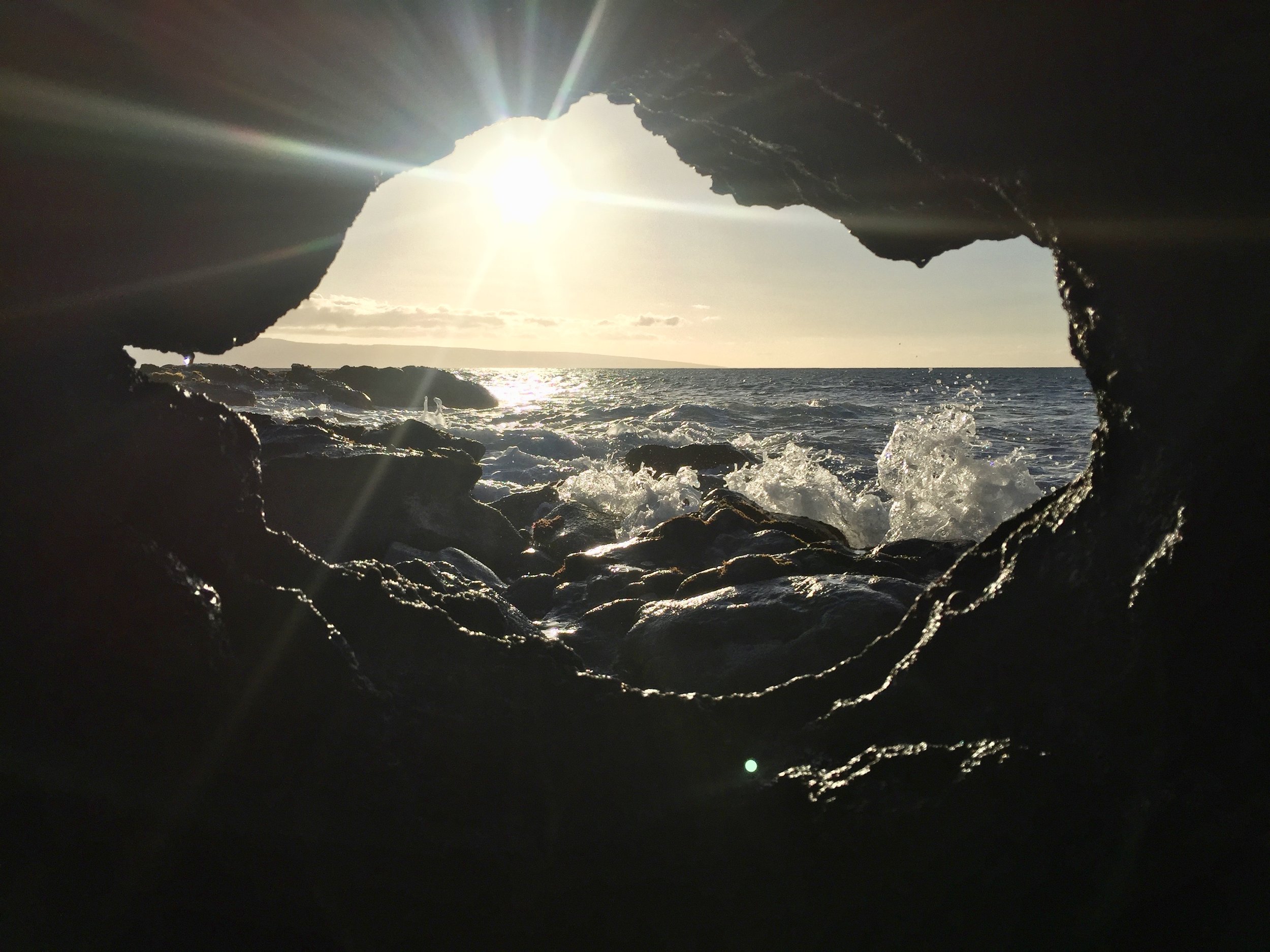 The ocean framed by lava on a beach in Maui (photo by: @thelotuspage )